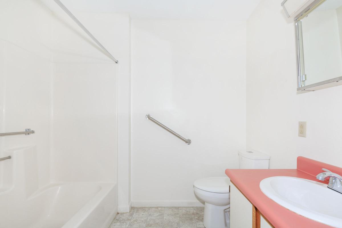 a white tub sitting next to a sink