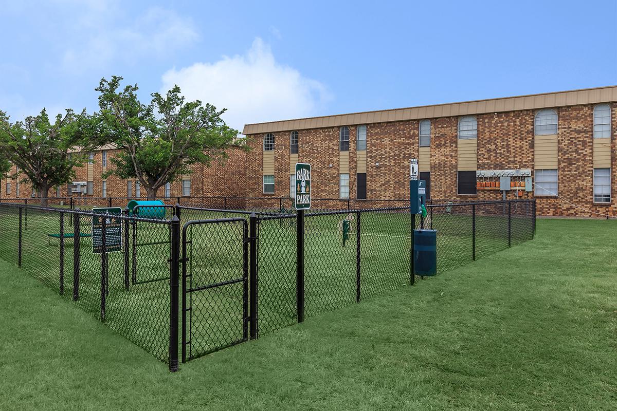 a building with a fence in a field