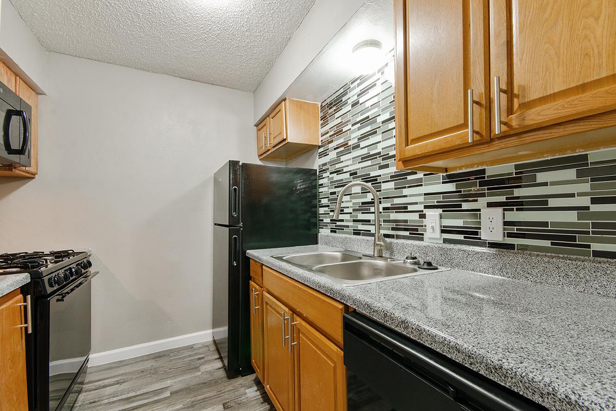 a kitchen with stainless steel appliances and wooden cabinets