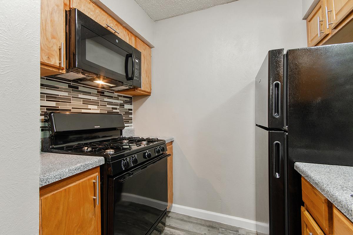 a stove top oven sitting inside of a kitchen