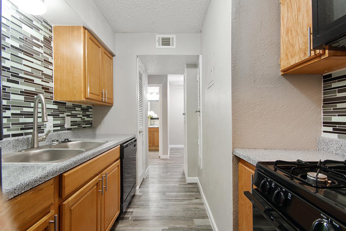 a kitchen with stainless steel appliances and wooden cabinets