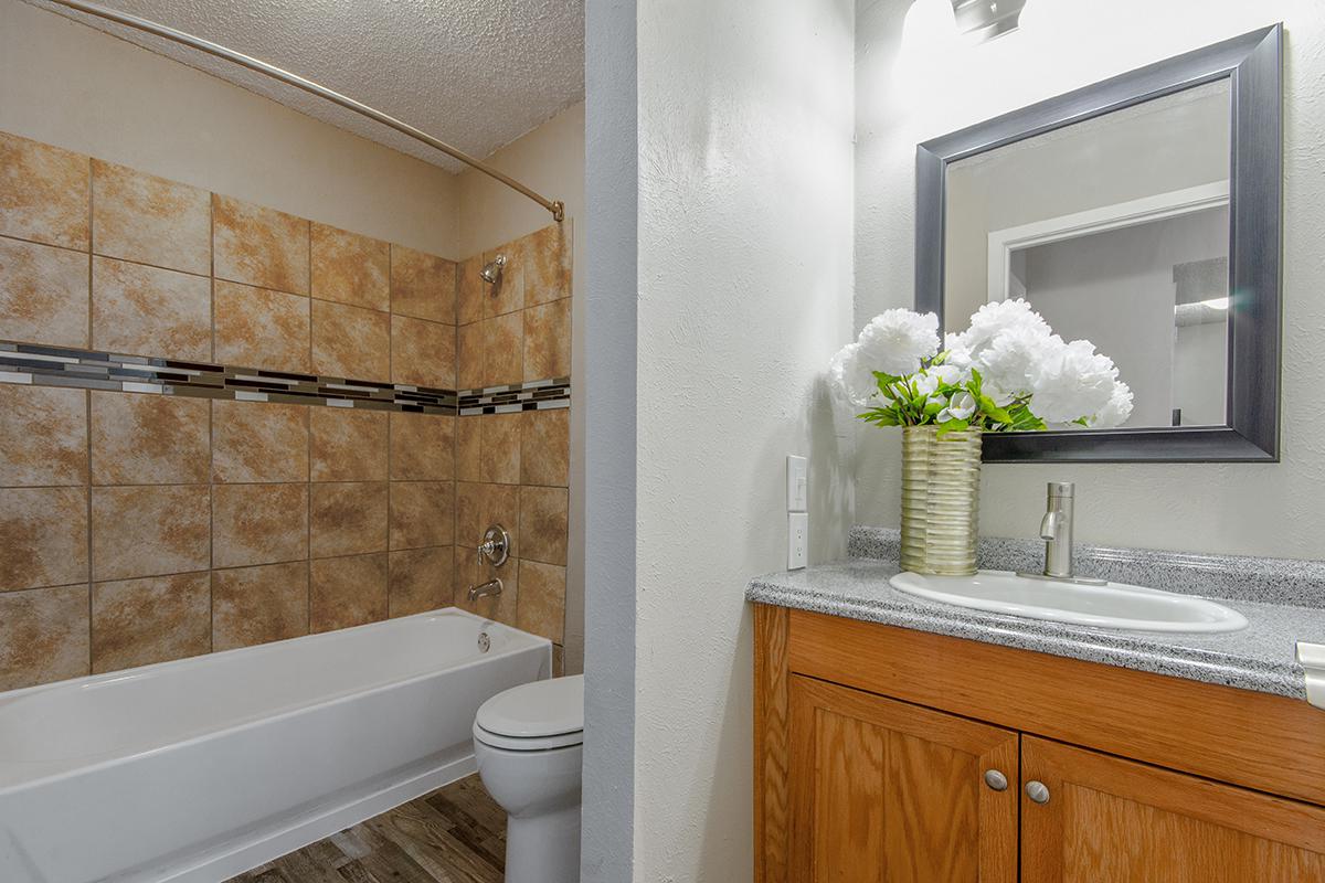 a large white tub next to a sink