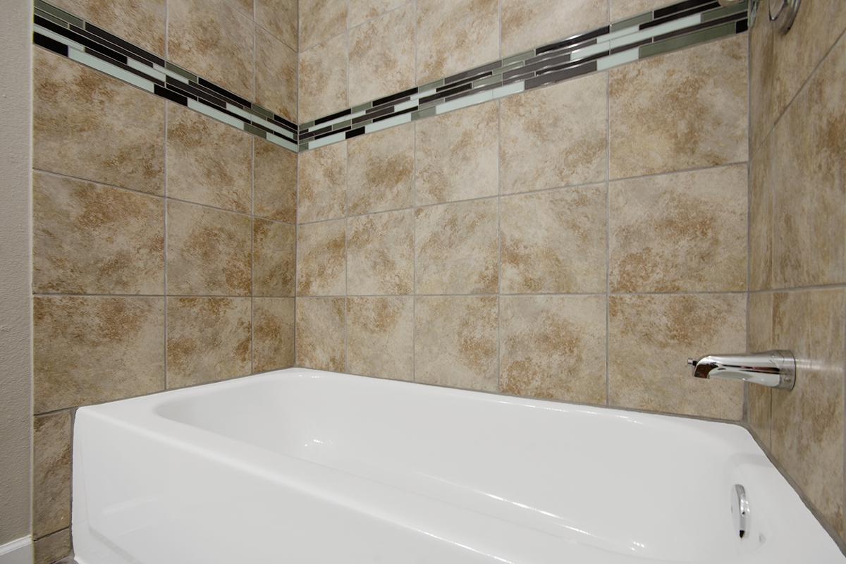 a white tub sitting next to a sink