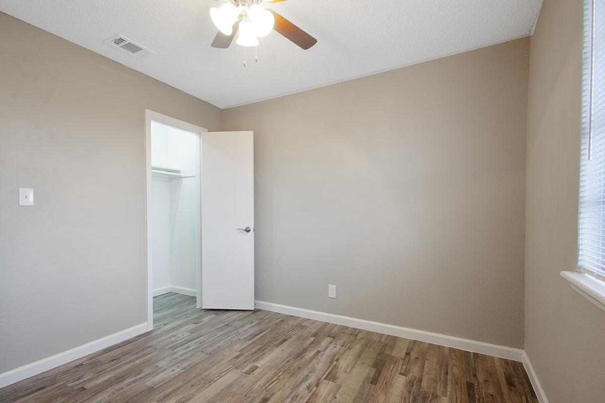 a large empty room with a sink and a mirror