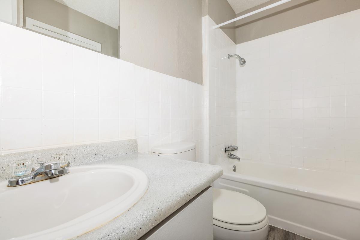 a white tub sitting next to a sink