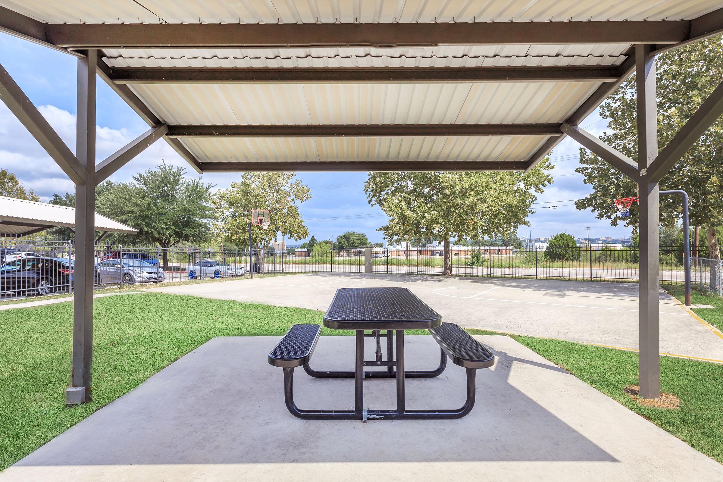 an empty park bench next to a building