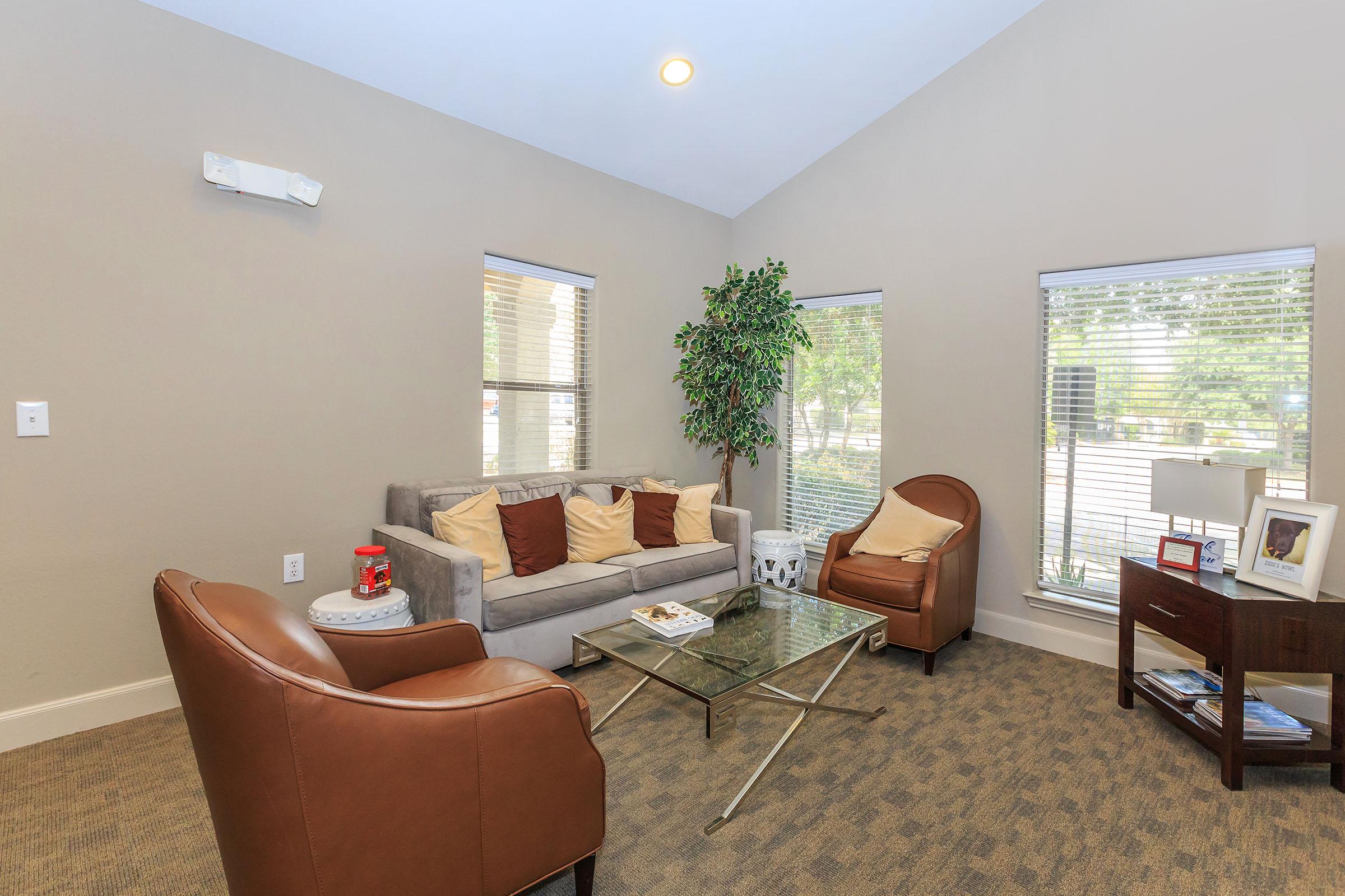 a living room filled with furniture and a large window