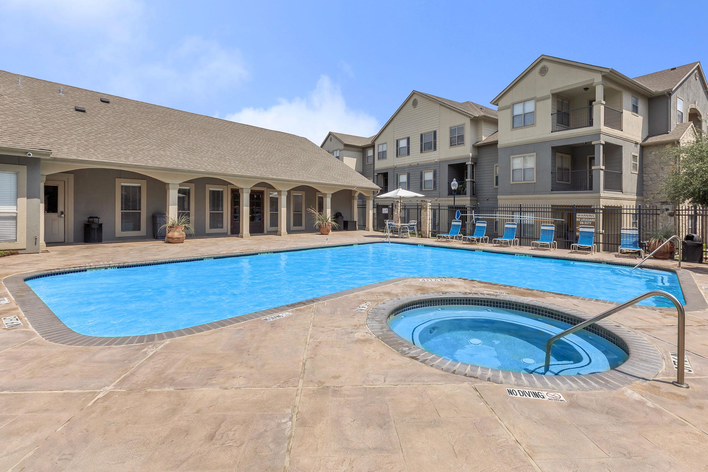 a house with a pool in front of a building