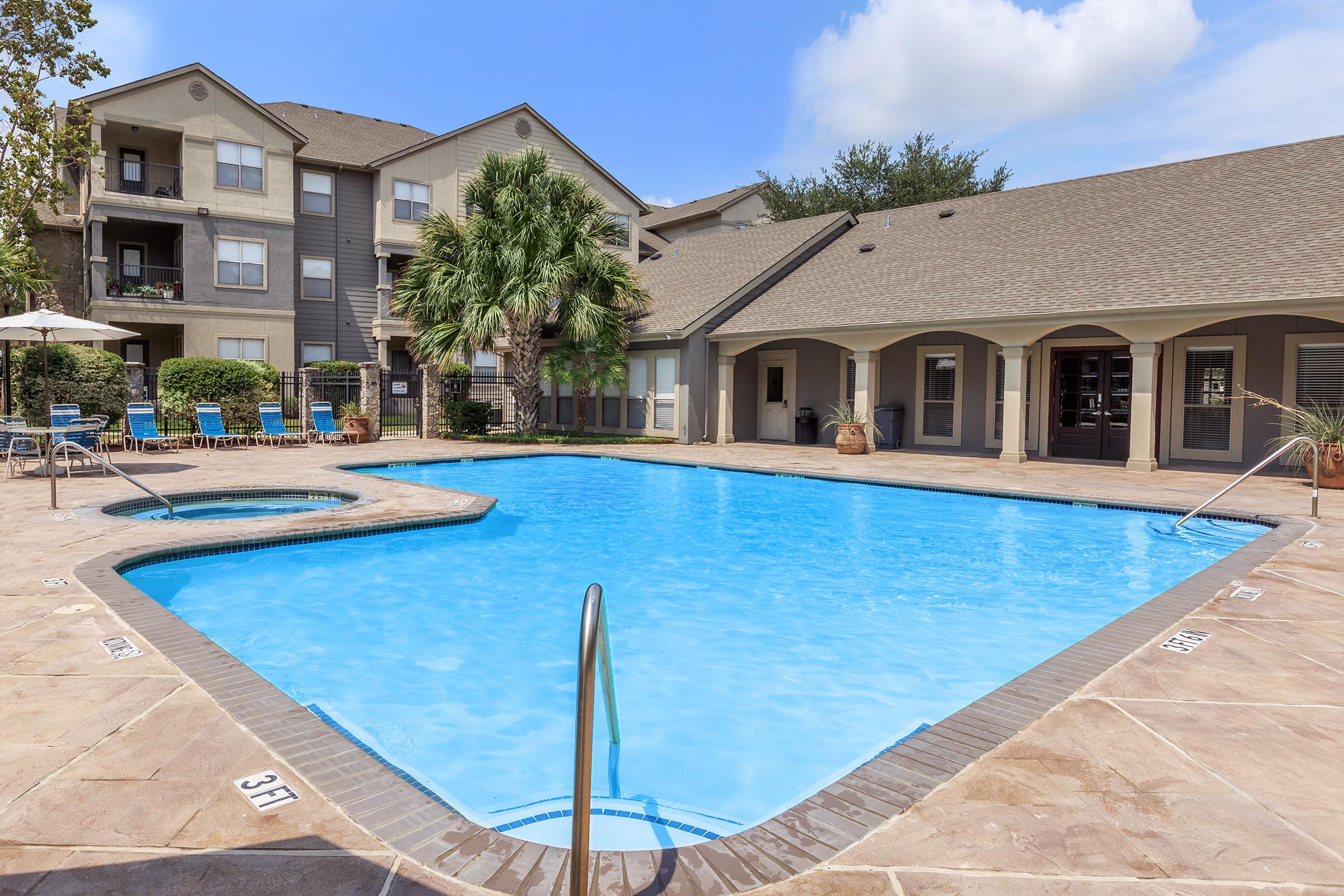 a large pool of water in front of a house