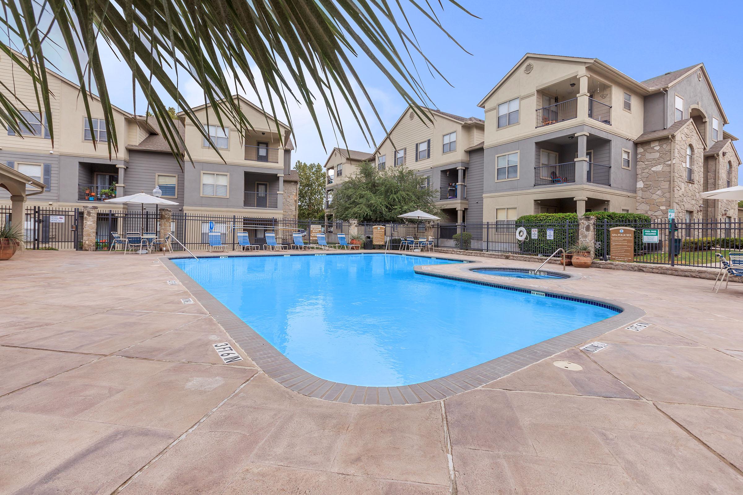 a house with a pool in front of a building