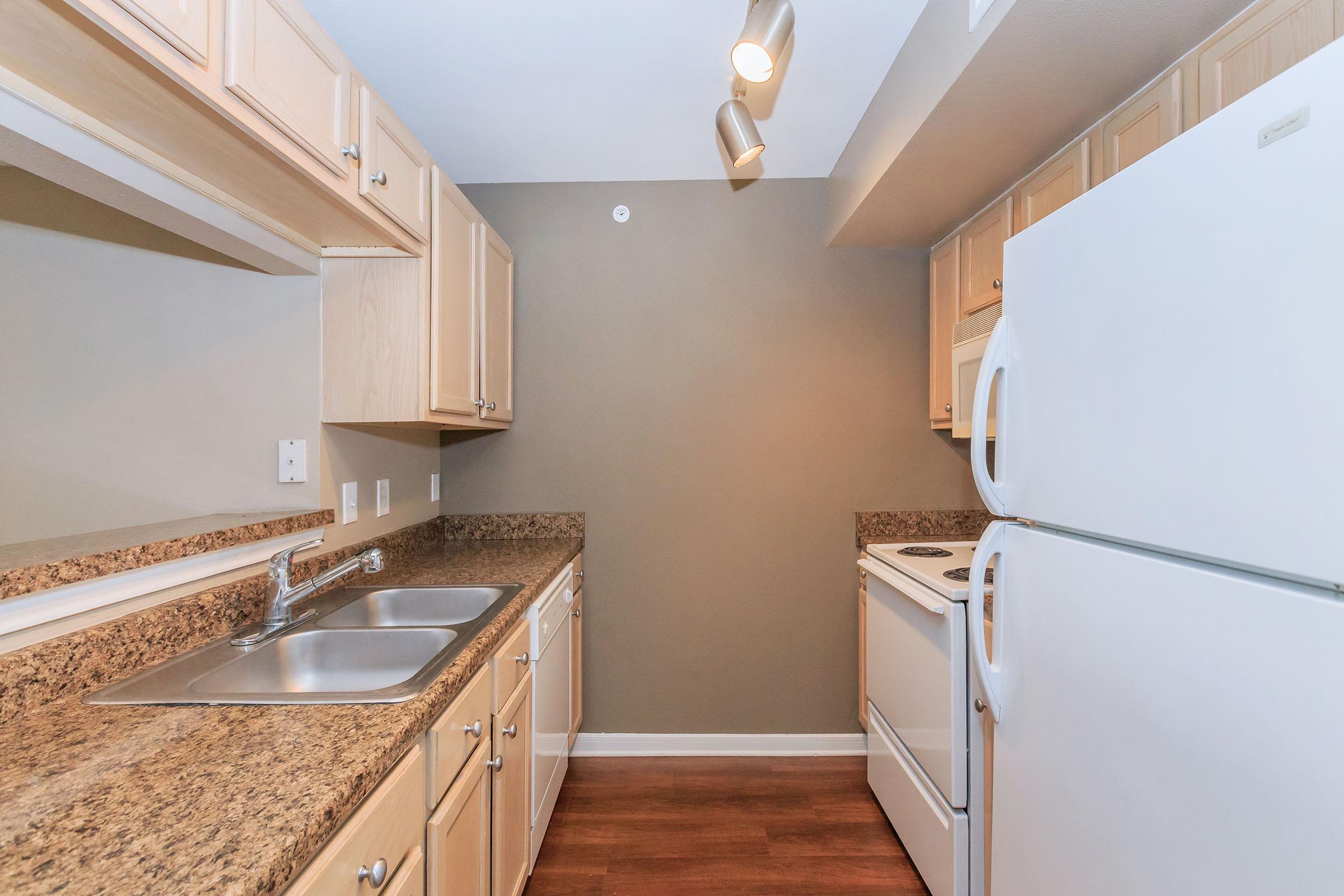 a kitchen with a stove sink and refrigerator