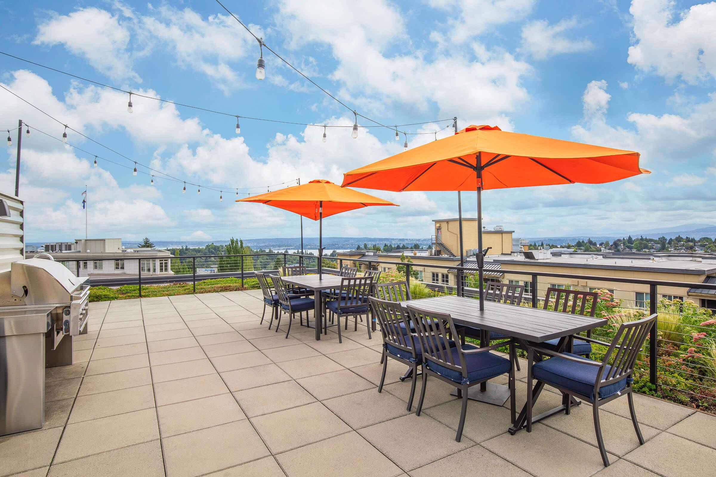 a group of lawn chairs sitting on top of a table umbrella