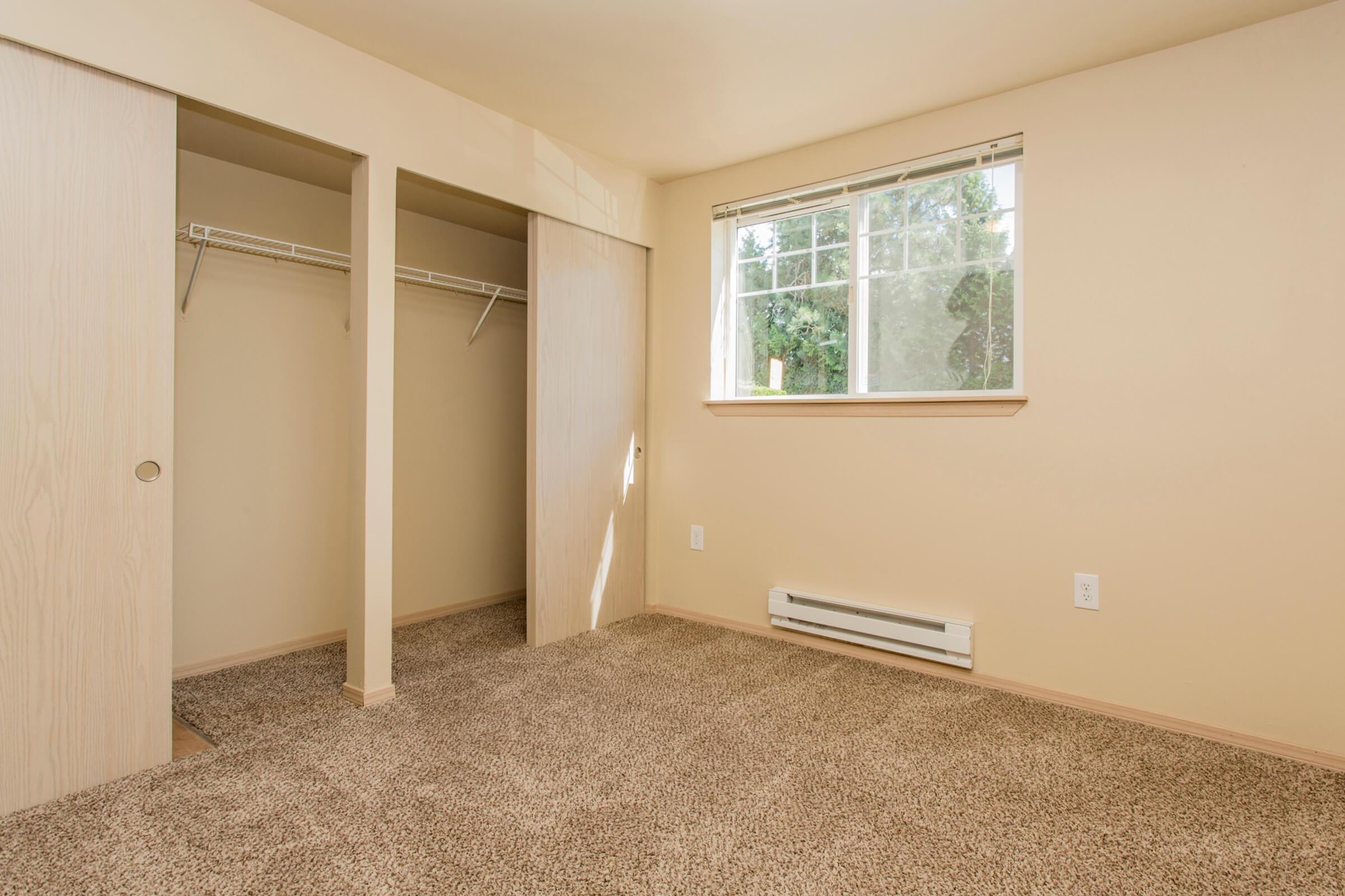 a bedroom with a large window