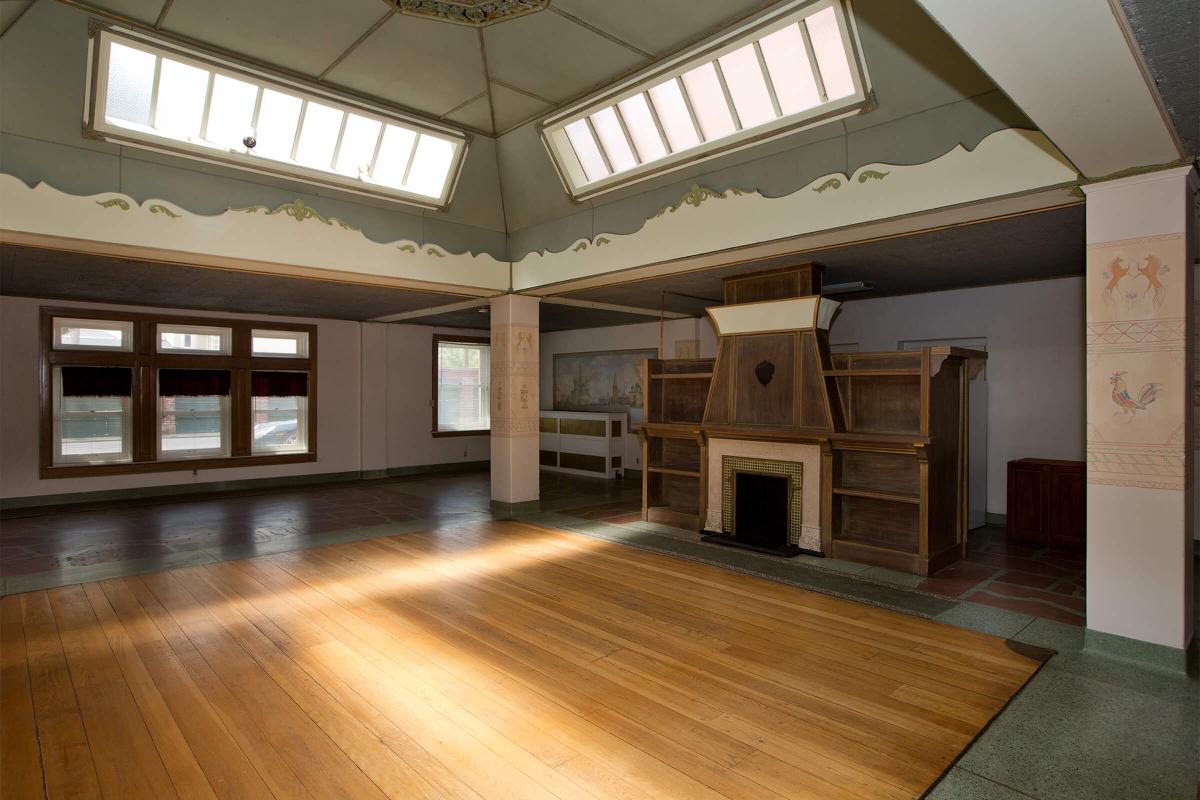 a large empty room with a wood floor