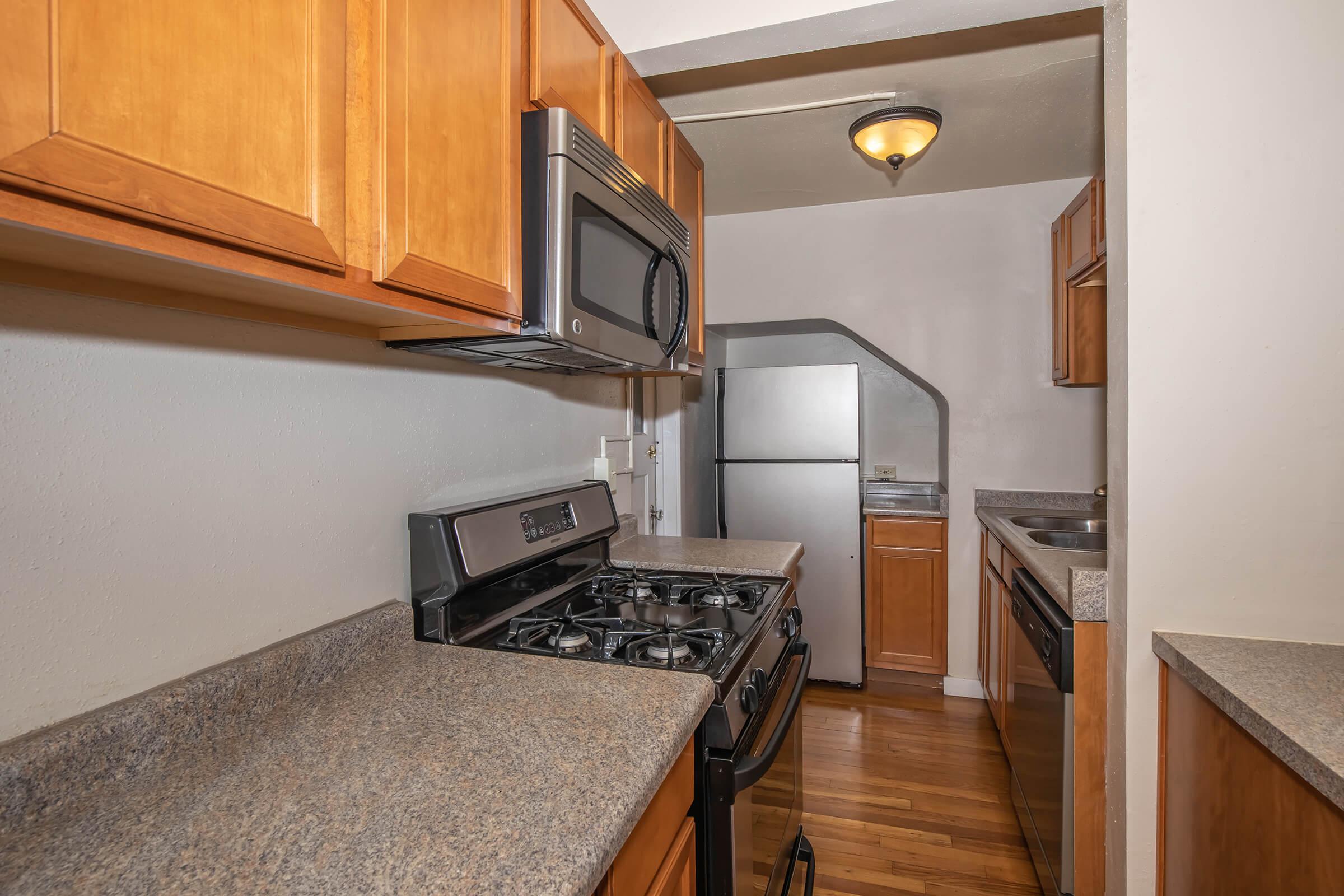 a stove top oven sitting inside of a kitchen