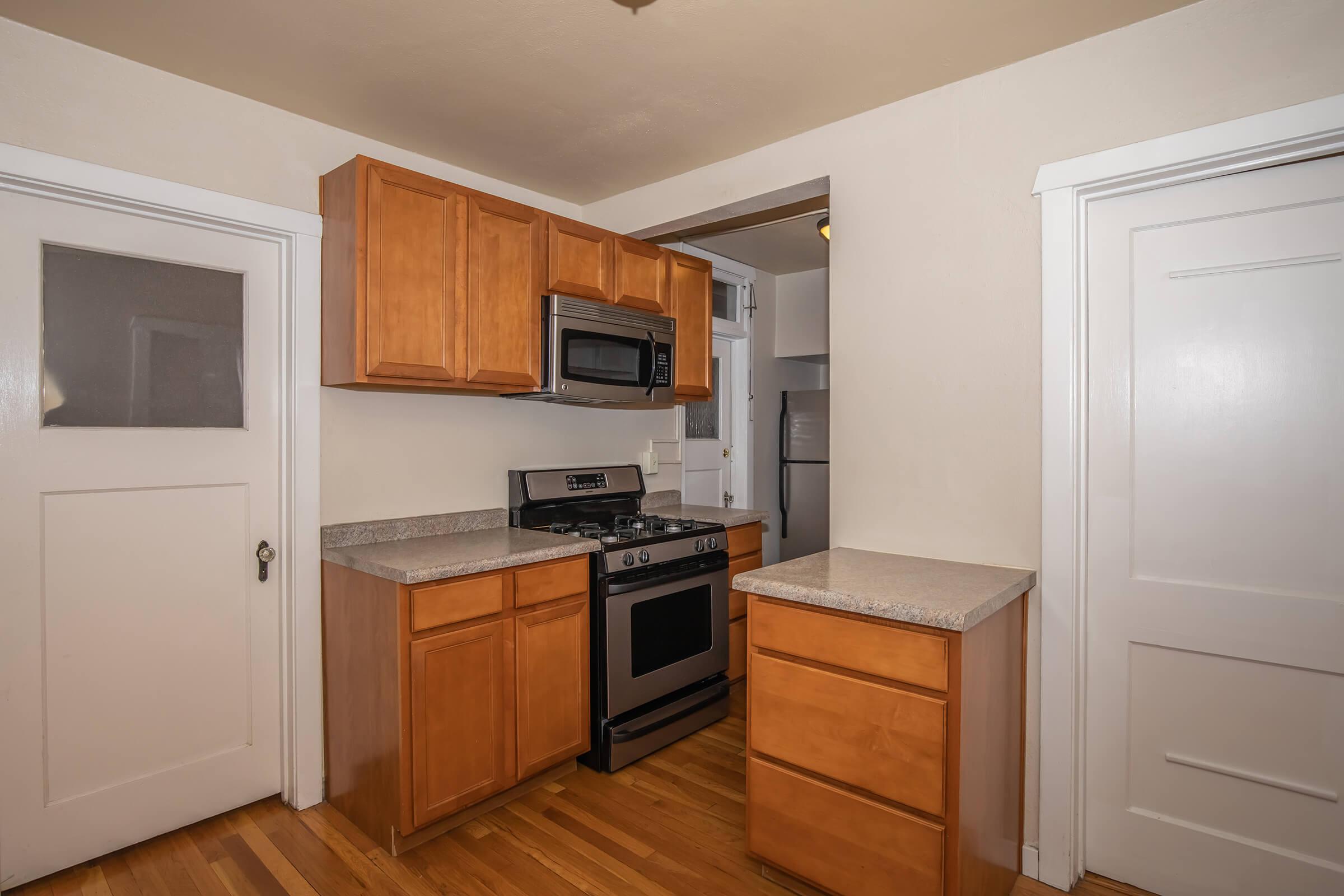 a kitchen with a refrigerator stove and microwave