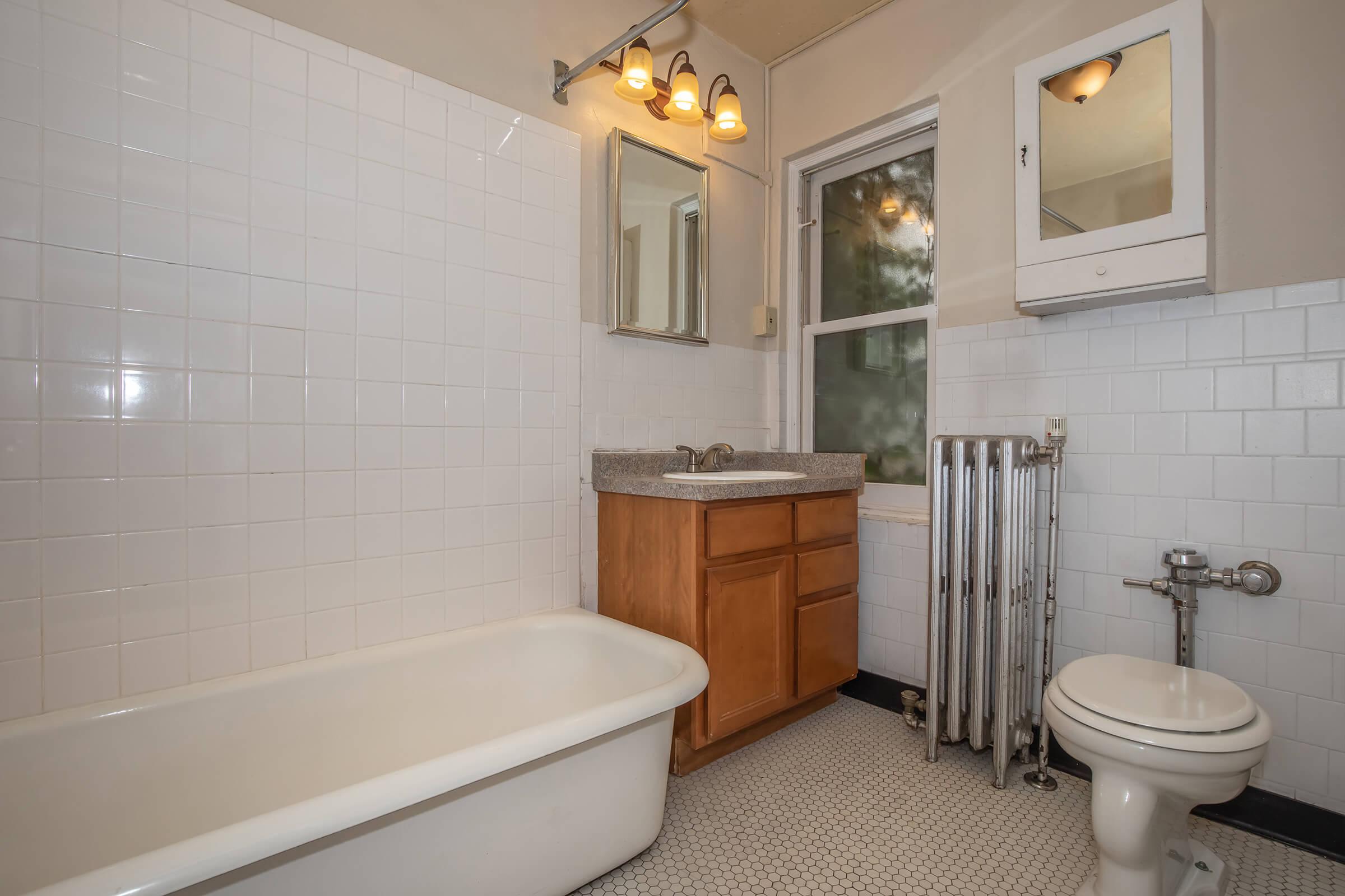 a large white tub sitting next to a sink