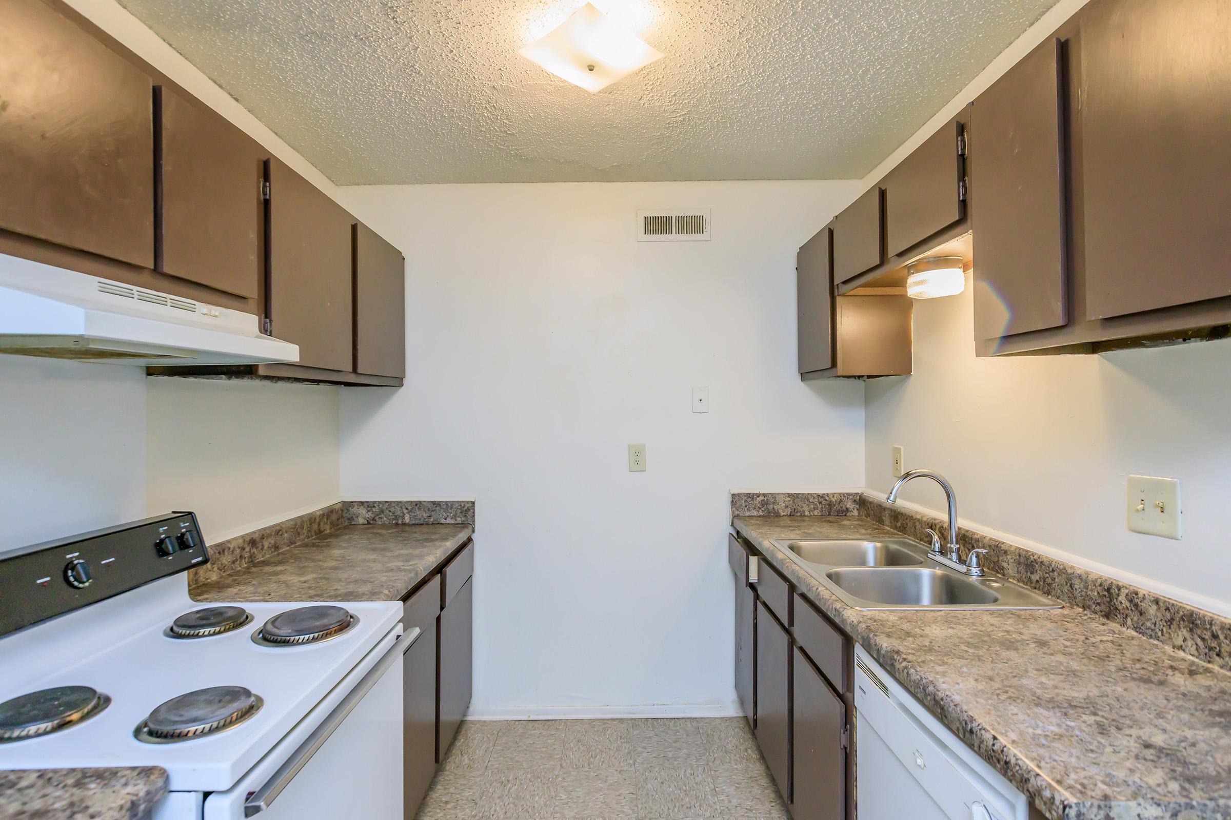 a kitchen with a stove and a sink