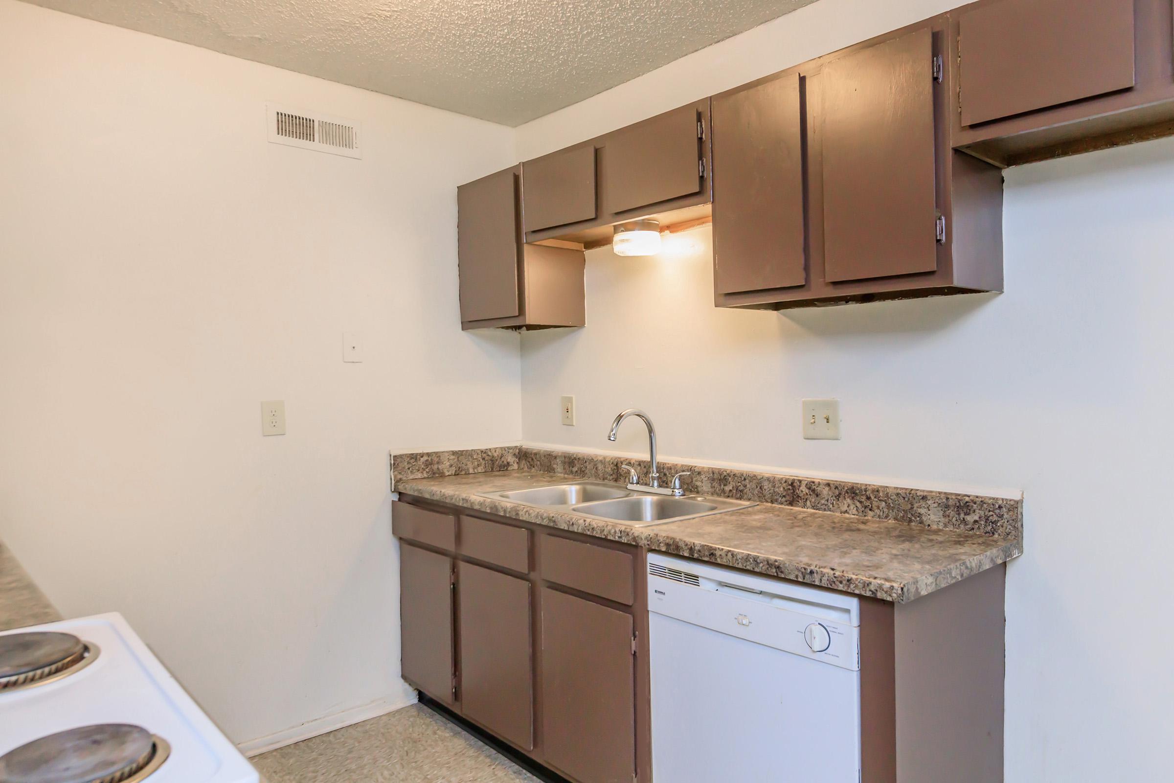 a kitchen with a sink and a mirror