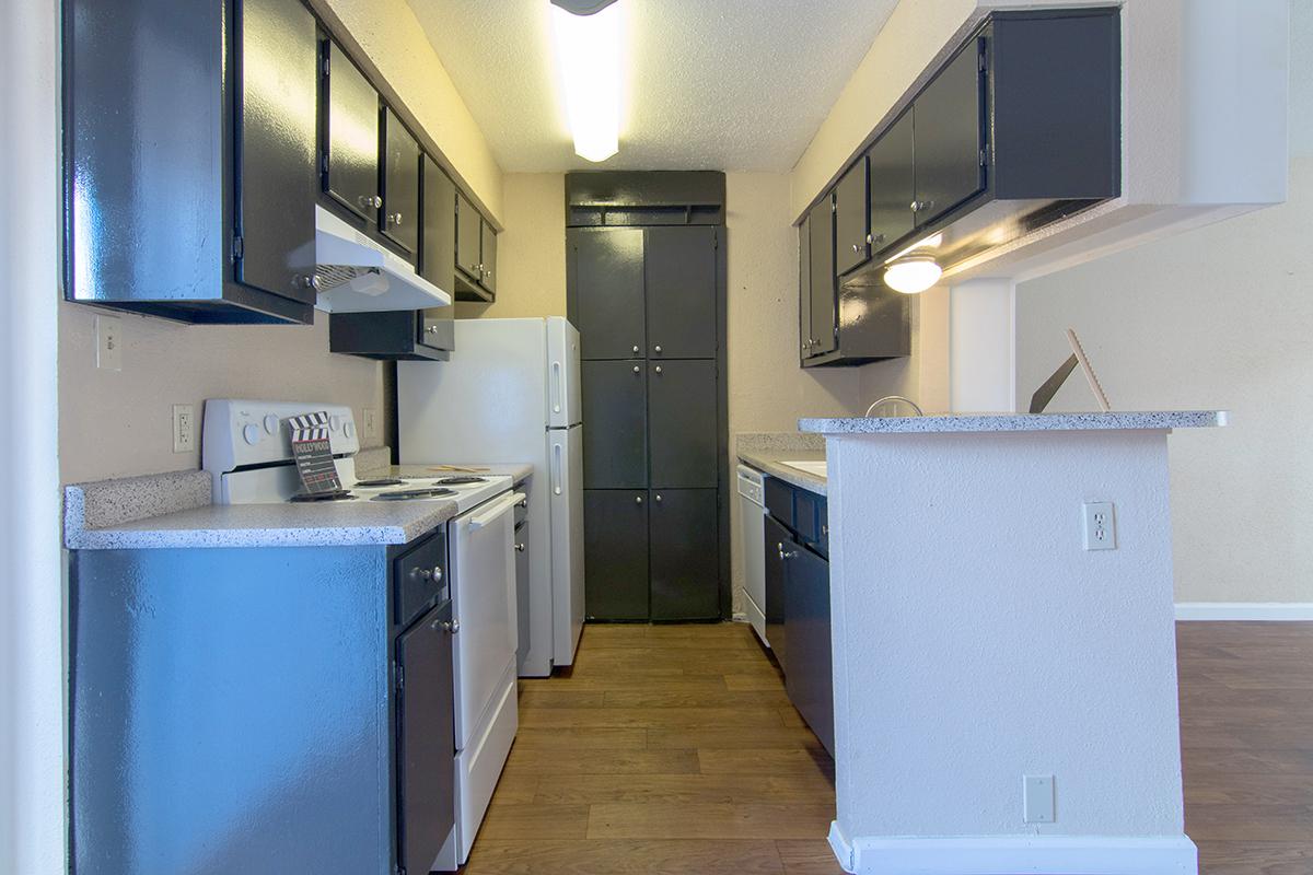 a kitchen with a sink and a refrigerator