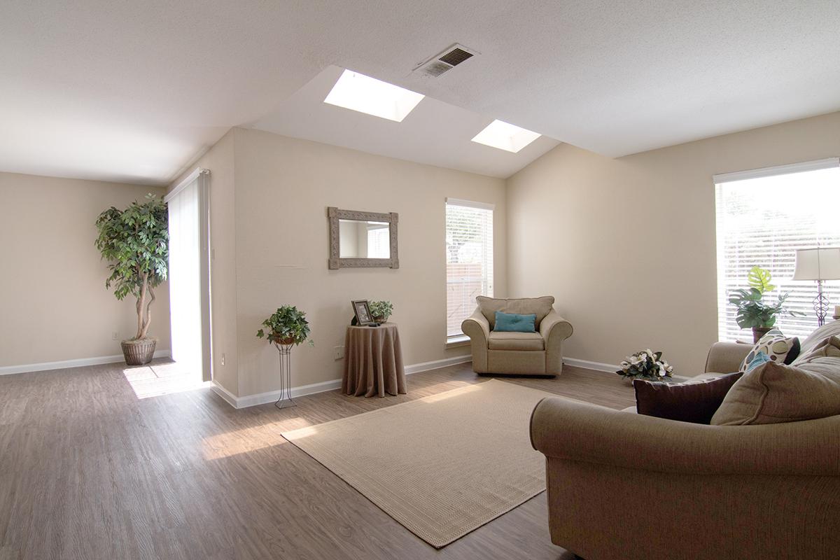 a view of a living room filled with furniture and a large window