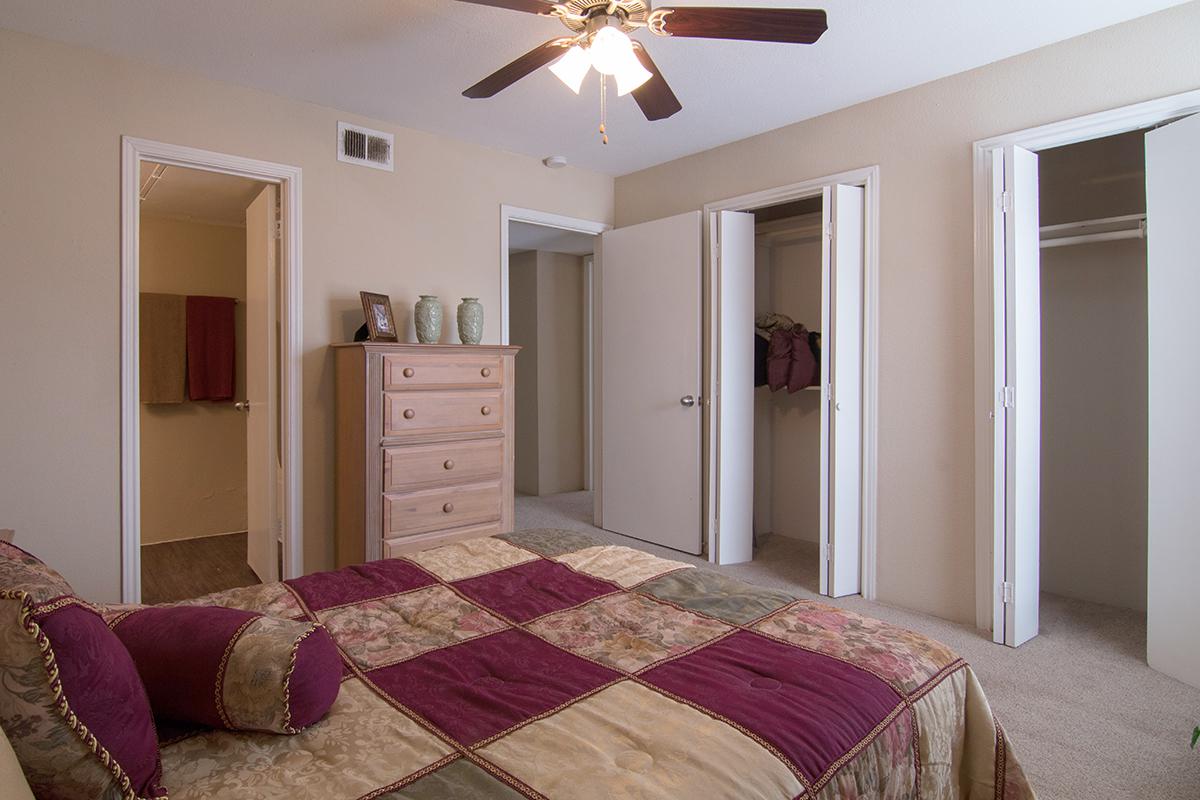 a bedroom with a red rug