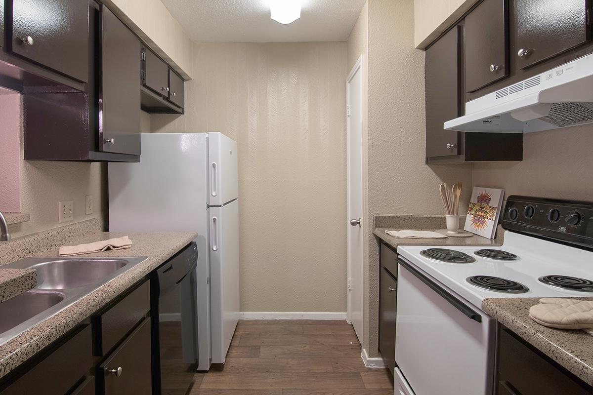 a kitchen with a stove sink and refrigerator