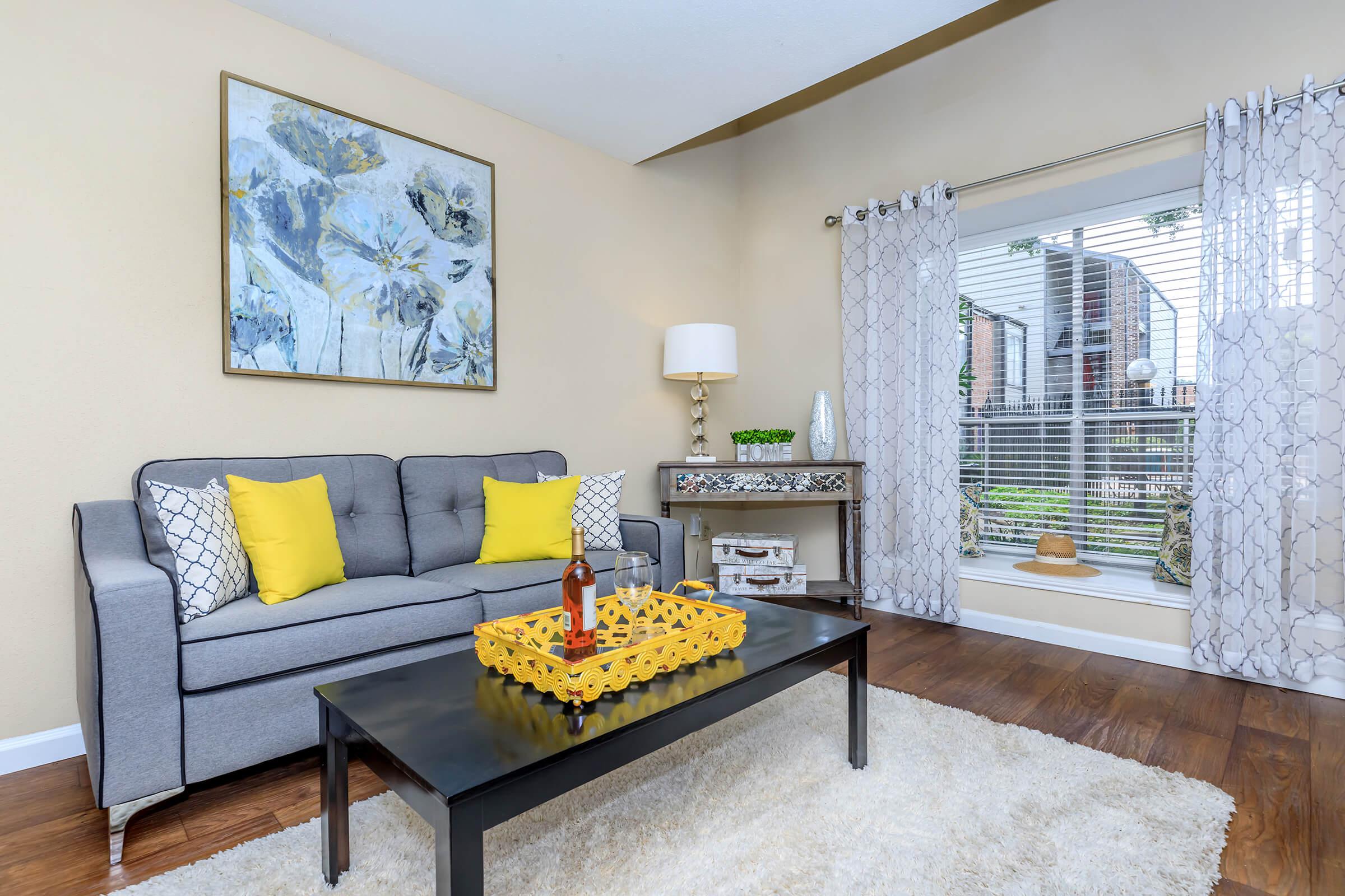 a living room filled with furniture and a large window