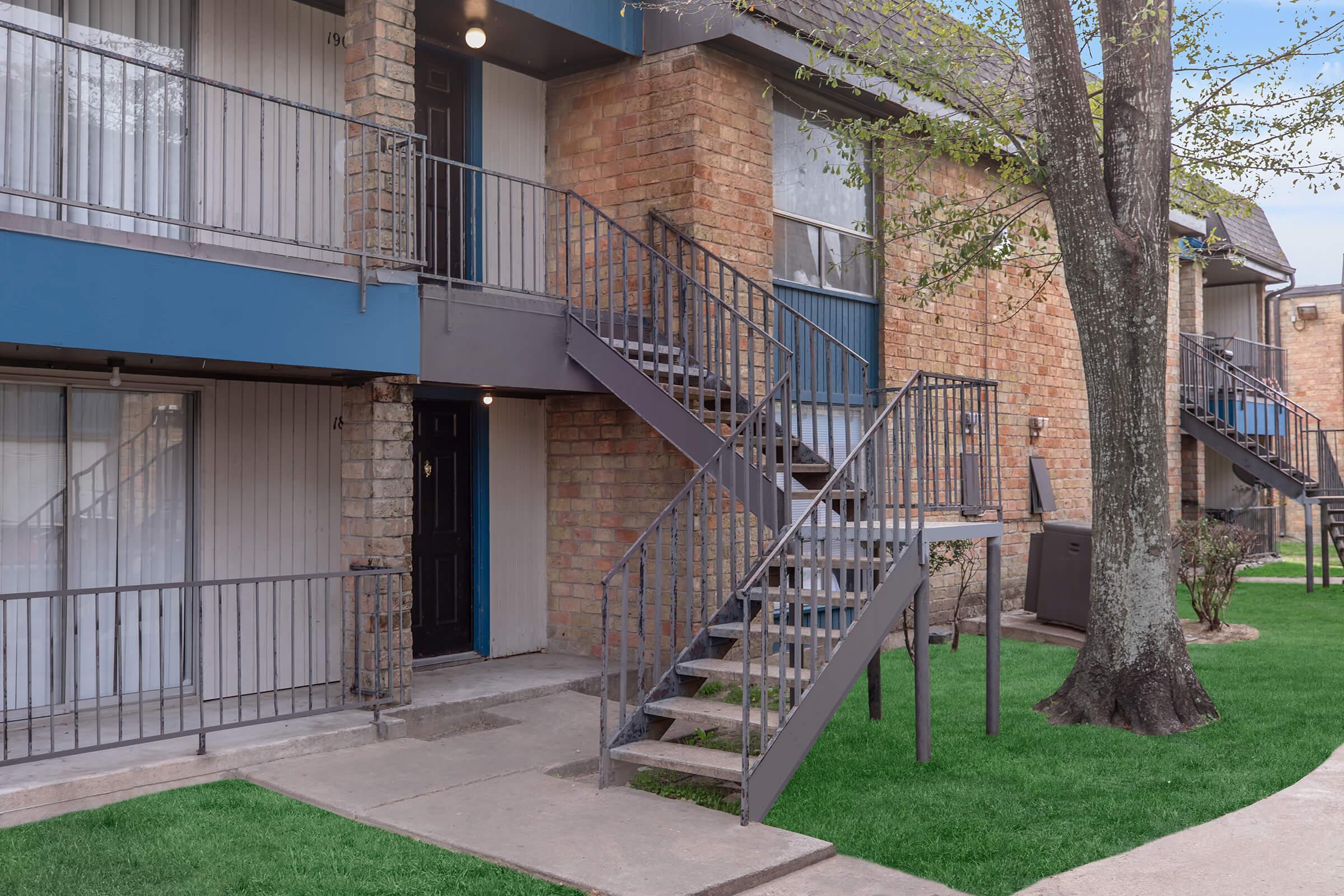 a house with a fence in front of a building