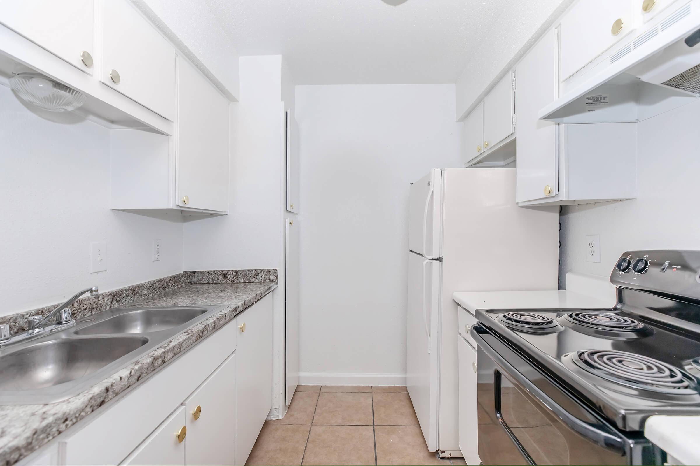 a stove top oven sitting inside of a kitchen