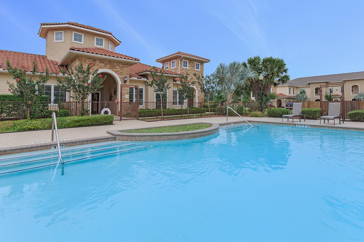 a large pool of water in front of a house