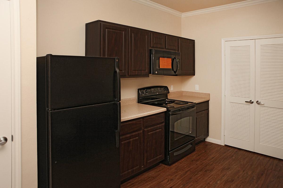 a kitchen with a stove and a refrigerator