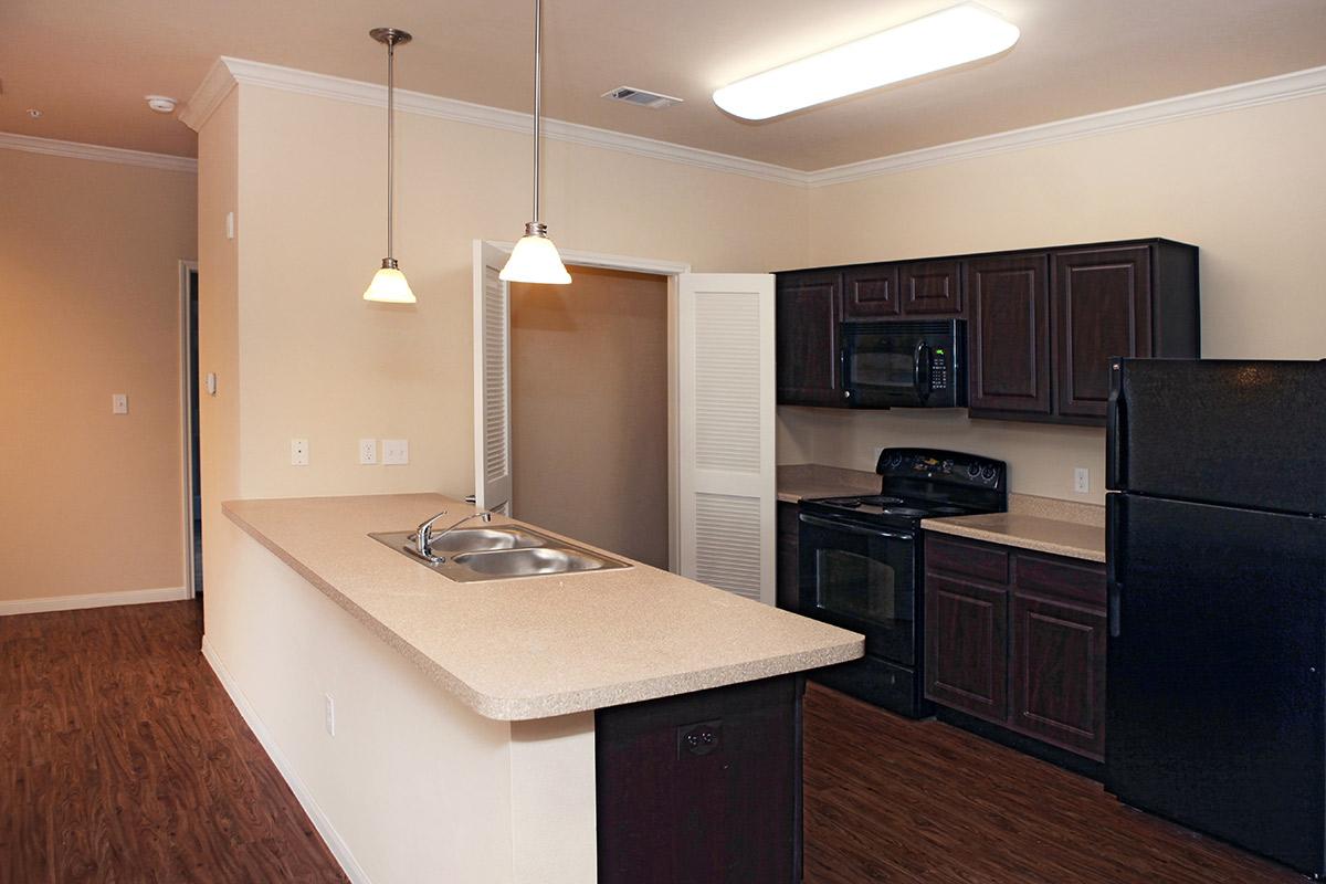 a kitchen with a sink and a refrigerator