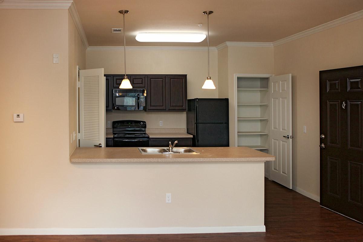 a kitchen with a sink and a mirror