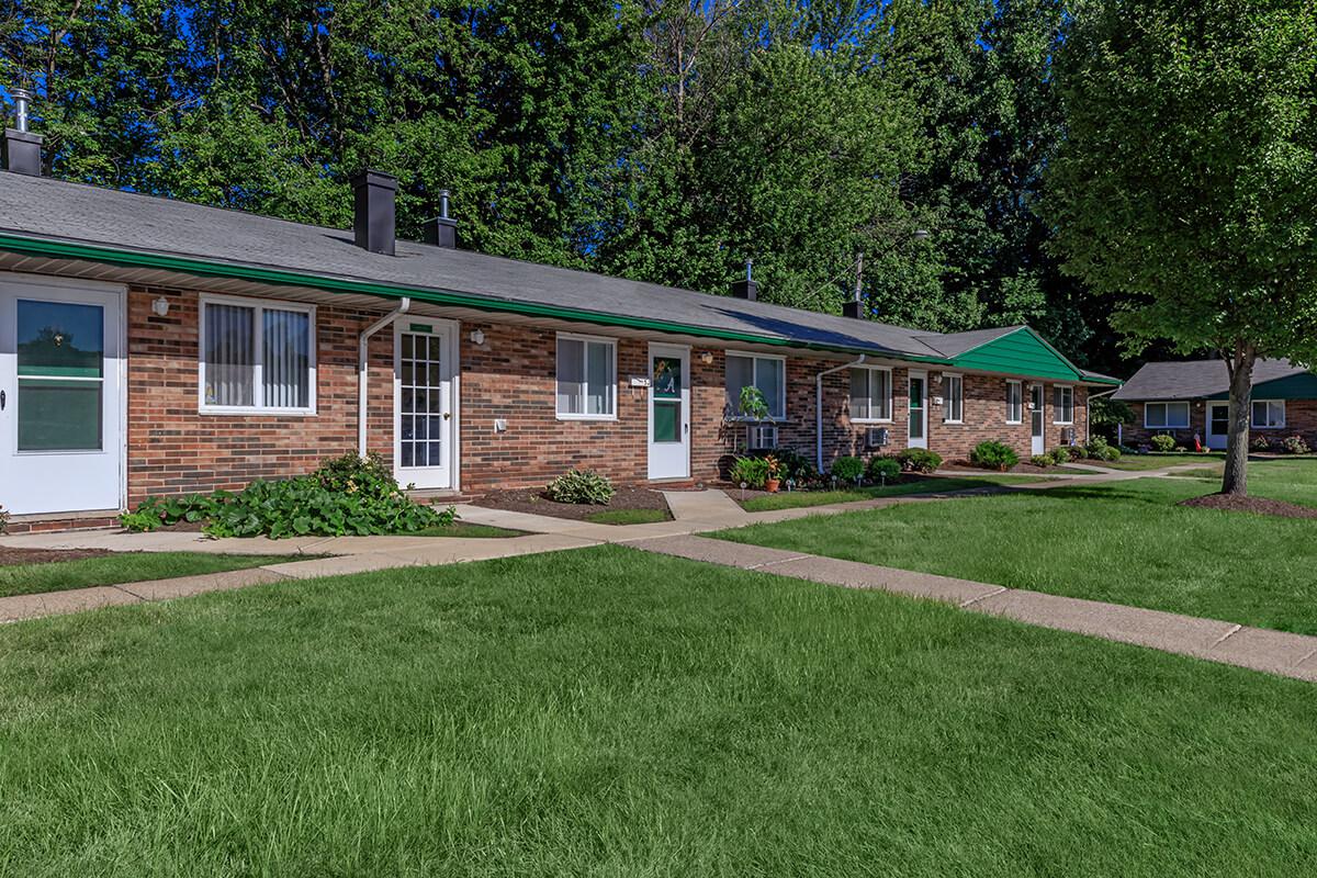 a house with a lawn in front of a building