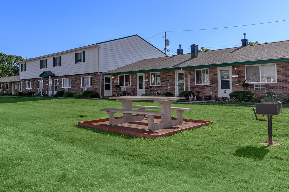 a house with a lawn in front of a building