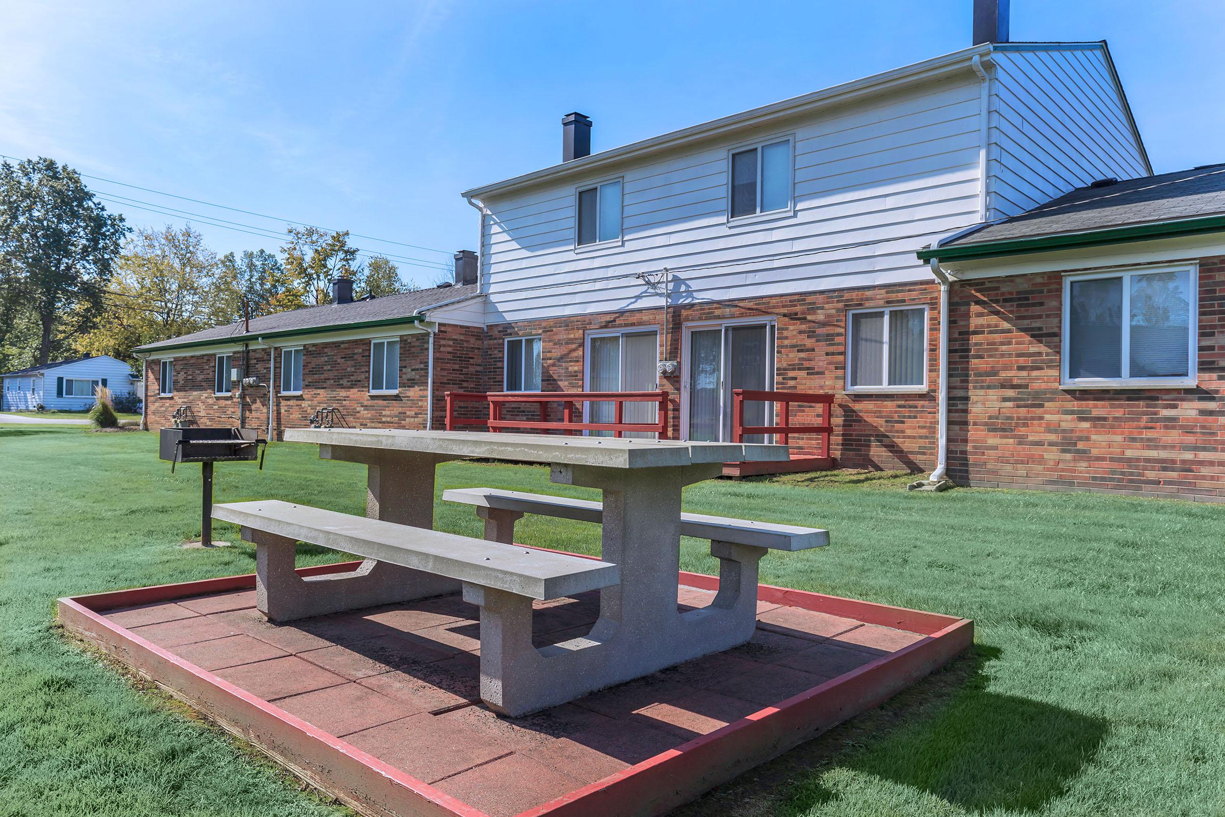 a wooden bench sitting in front of a building