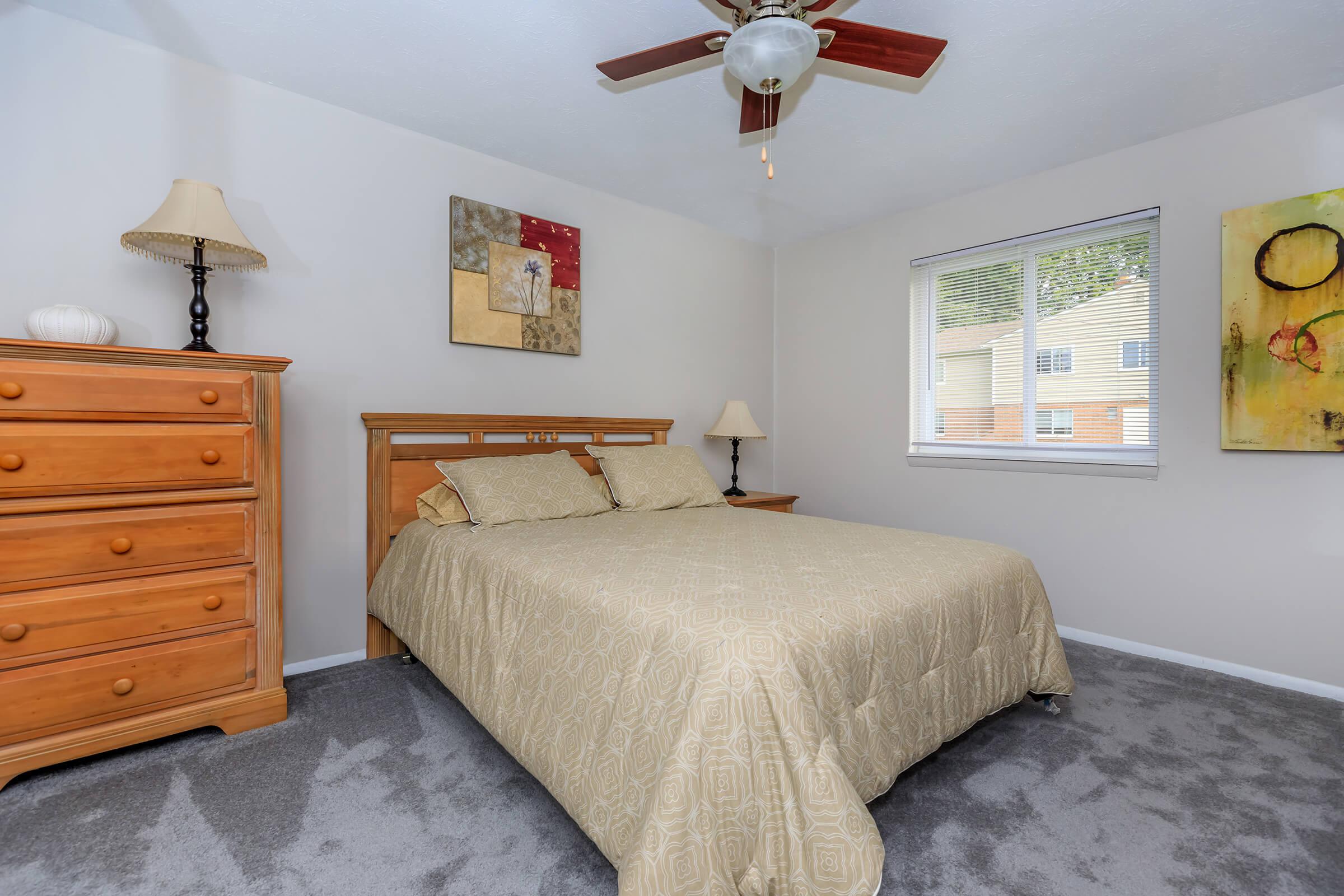 a bedroom with a bed and desk in a room