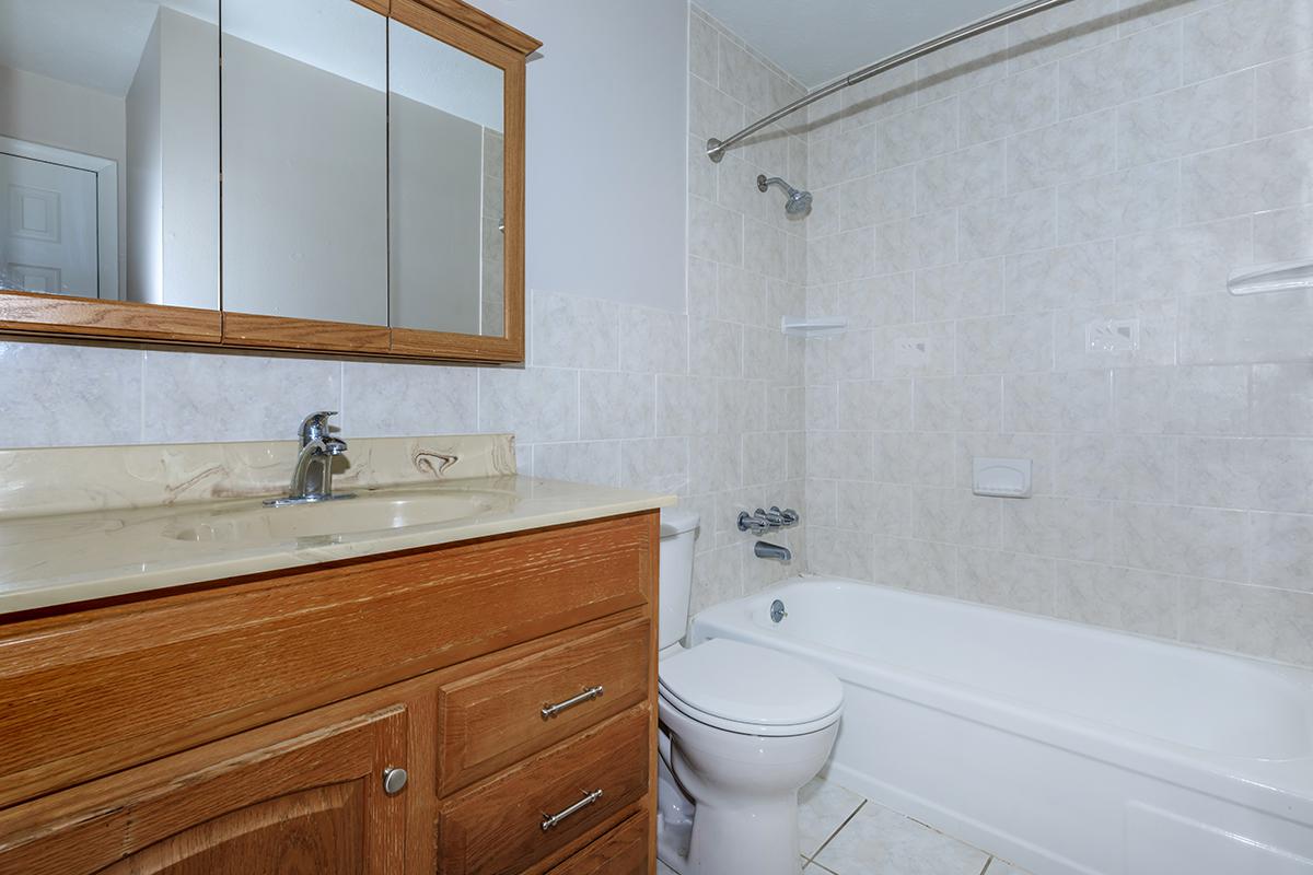 a white tub sitting next to a sink