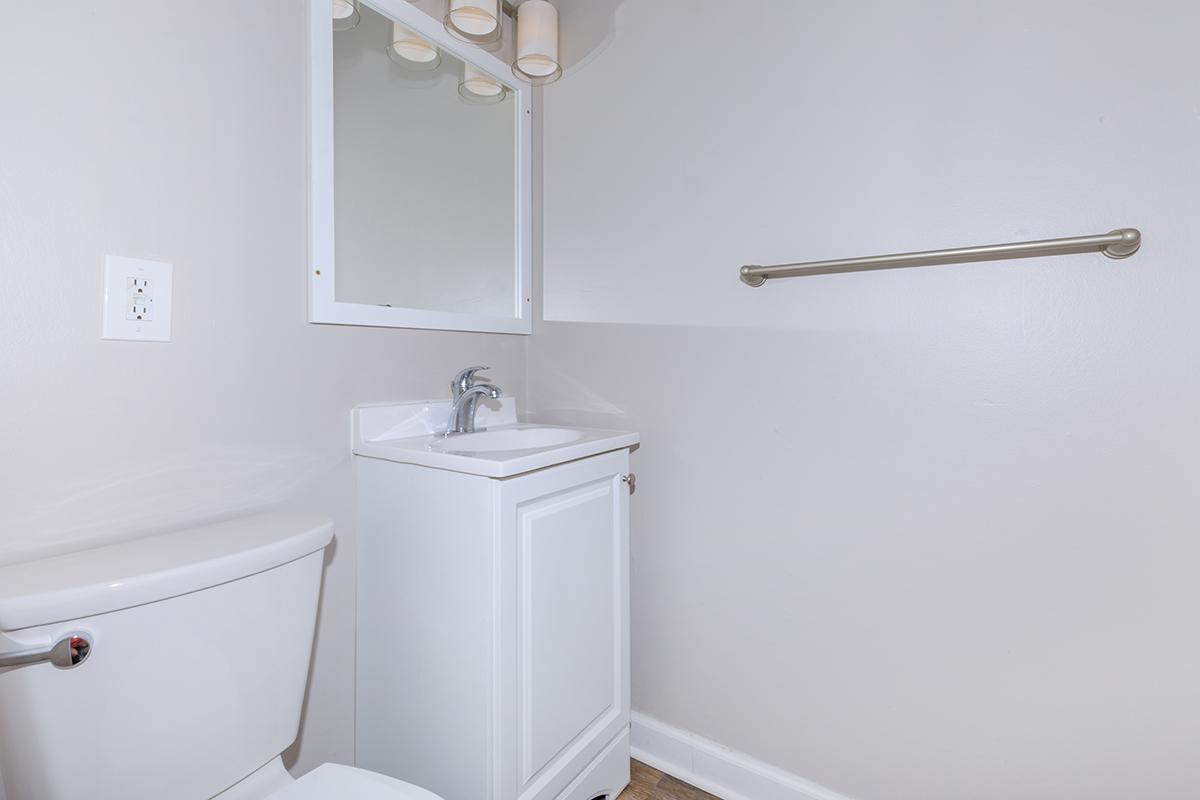 a white tub sitting next to a shower