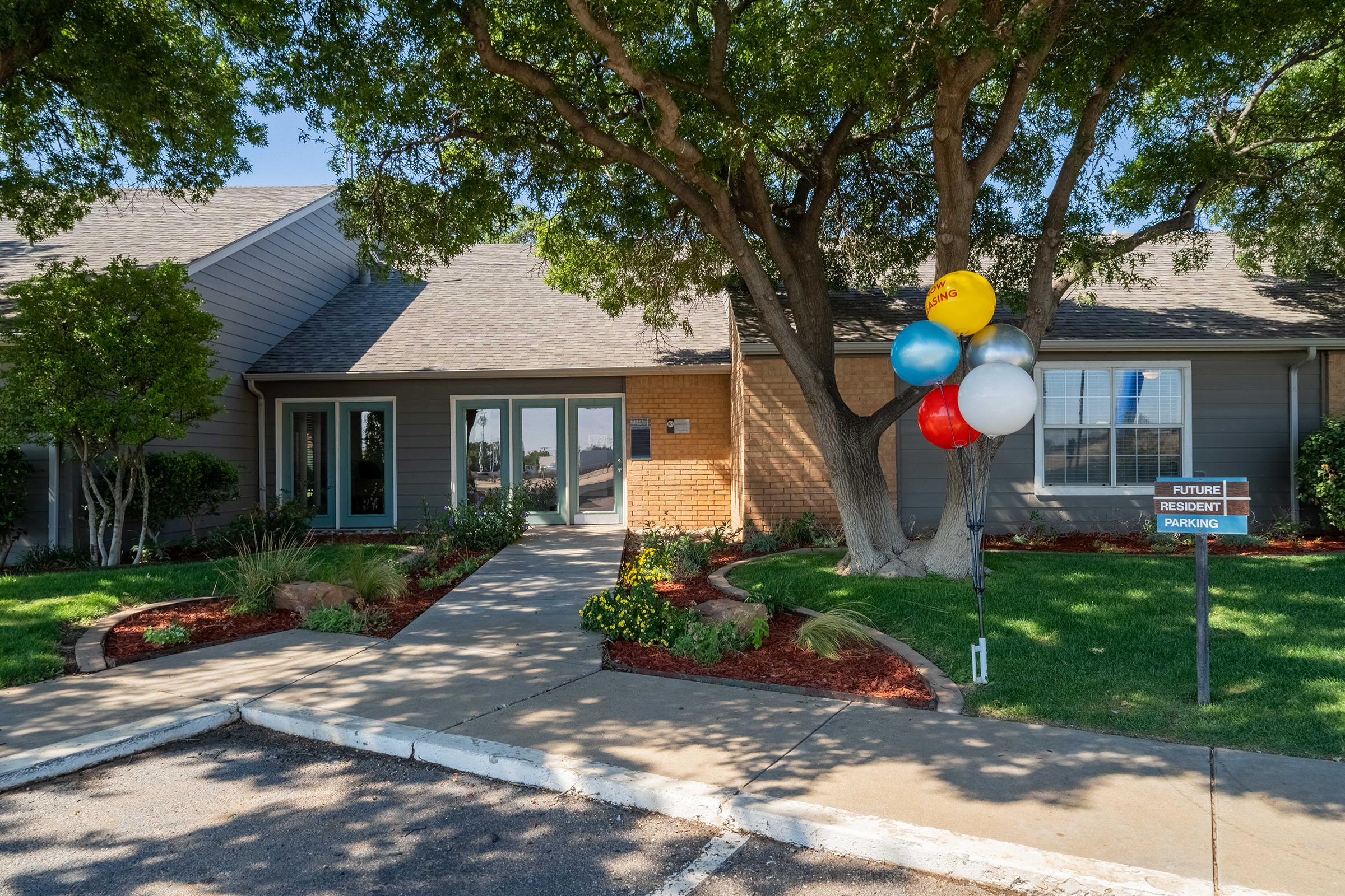 a tree in front of a house