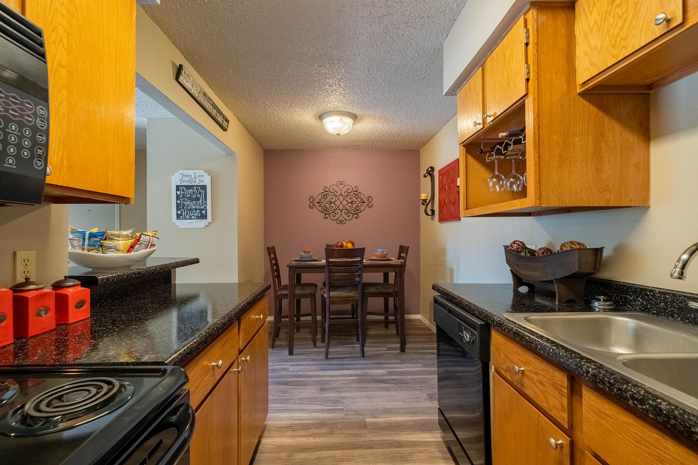 a kitchen with a stove top oven sitting inside of a room