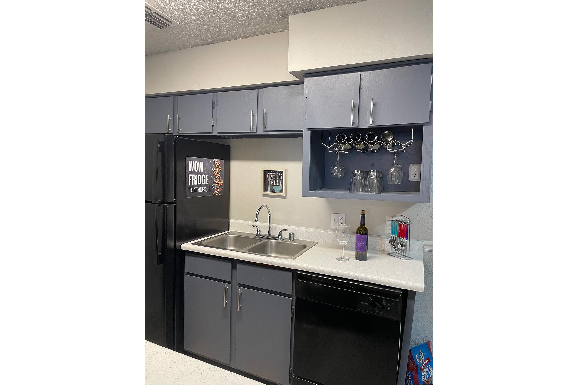 a kitchen with a sink and a refrigerator