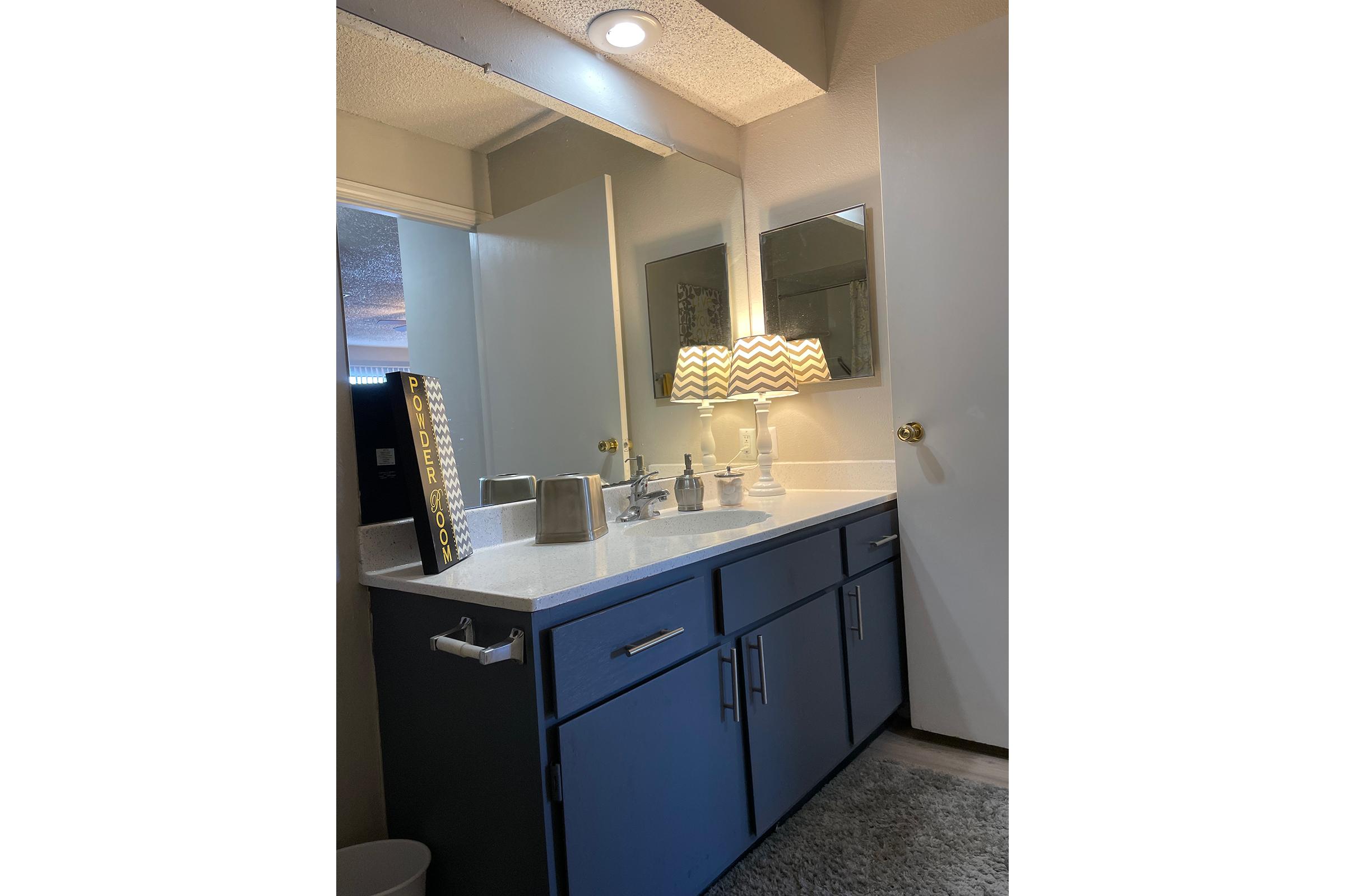 a kitchen with a sink and a mirror