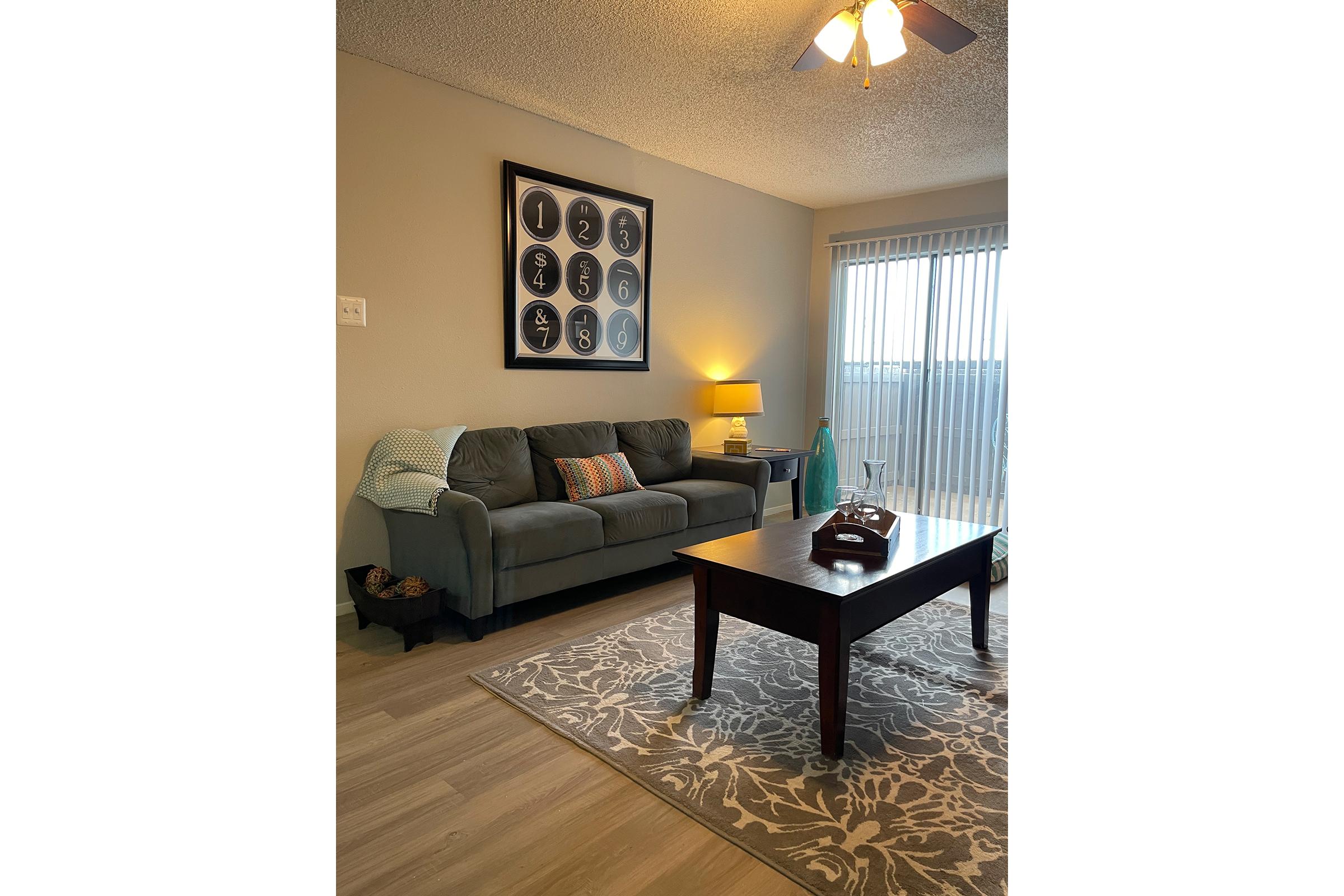 a living room filled with furniture and a large window