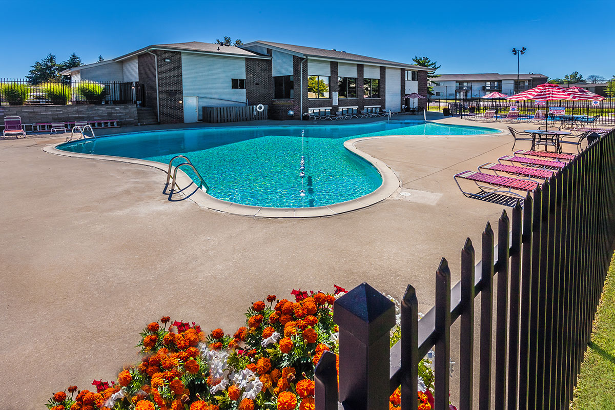 a group of lawn chairs sitting on top of a pool