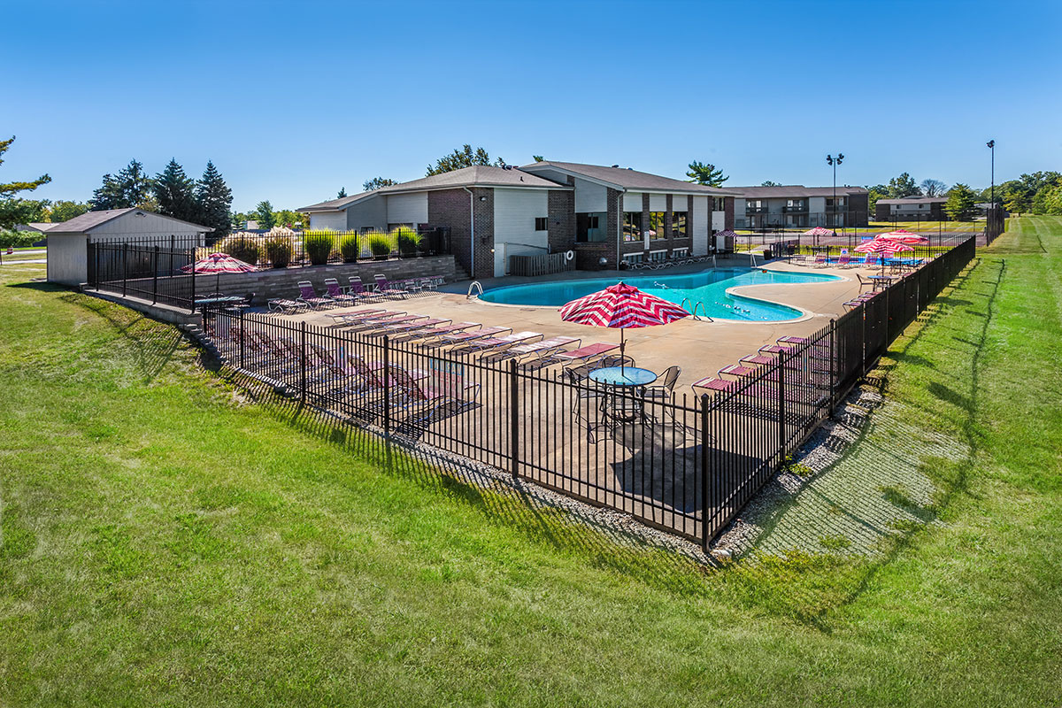 a building with a fence in a grassy area