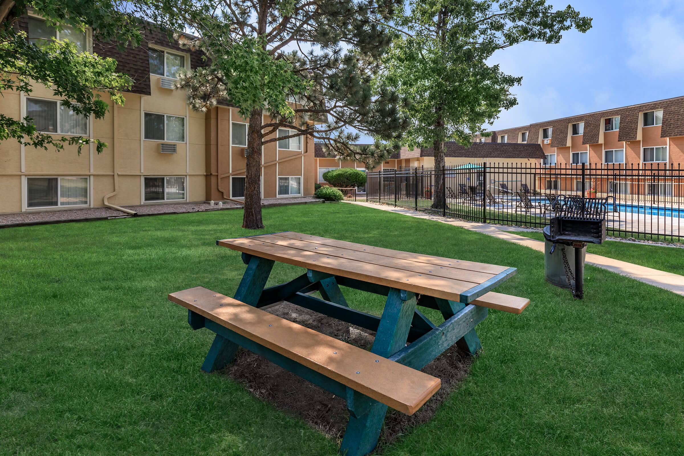 a couple of lawn chairs sitting on top of a wooden bench