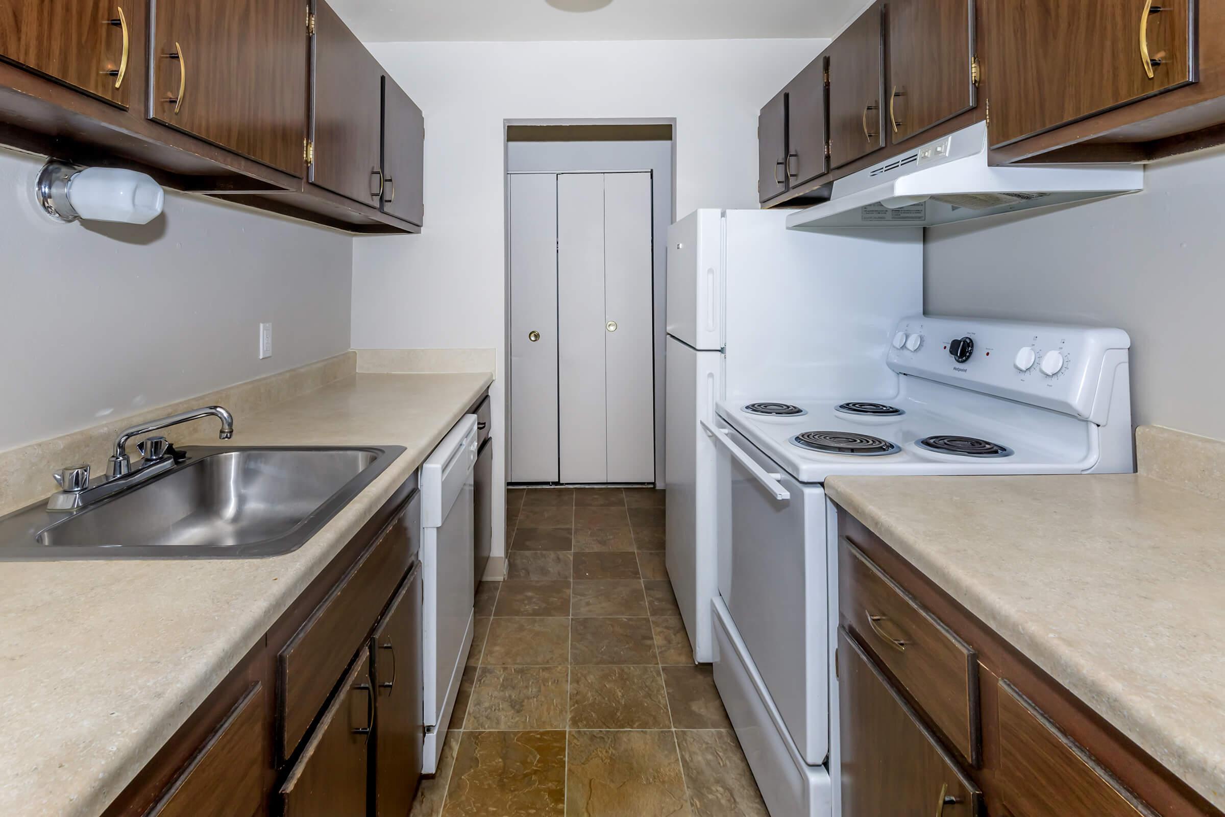 a kitchen with a sink and a mirror