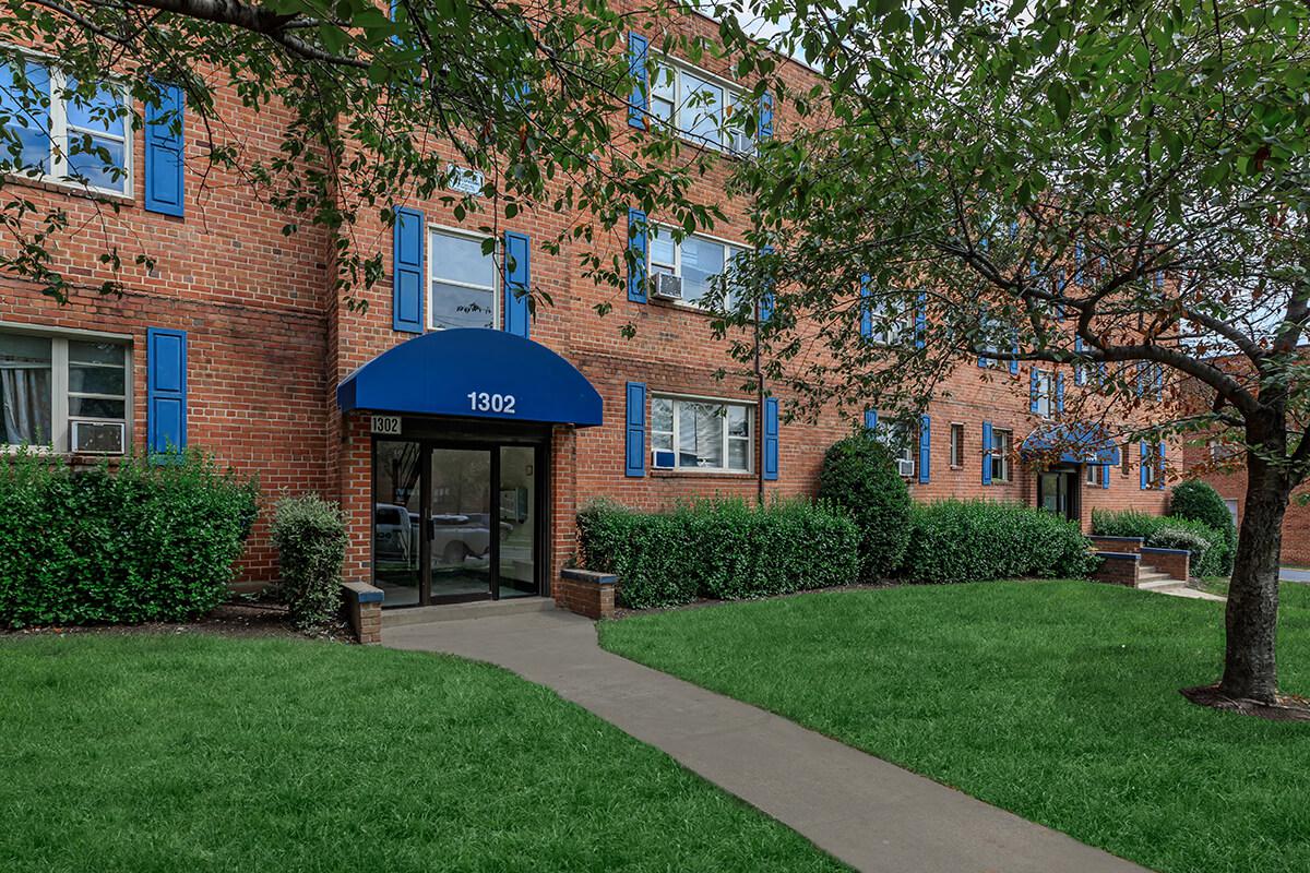 a house with a lawn in front of a building